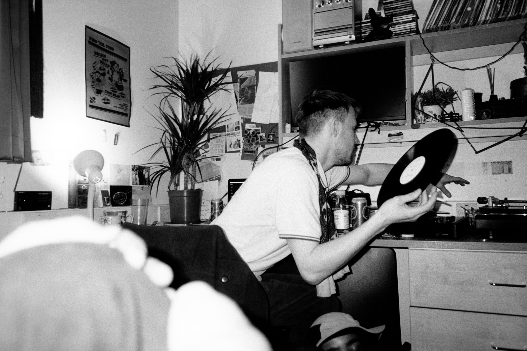 Photo by Evie Shandilya of a boy putting a record on in a bedroom in the book 'I Just Want to Party'