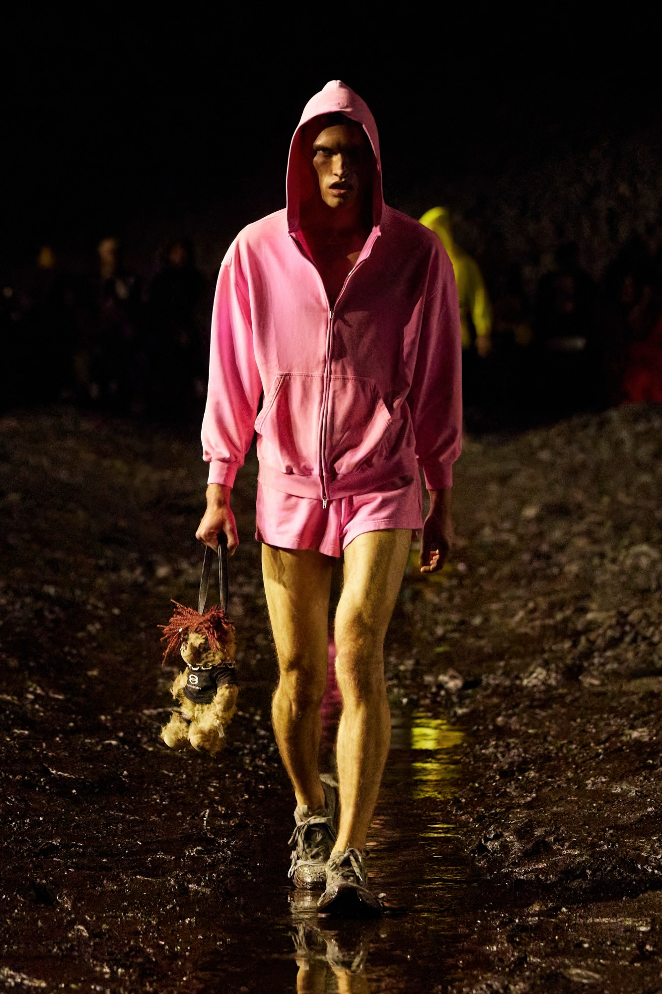 a model walks for balenciaga ss23 wearing a pink hoodie and matching shorts