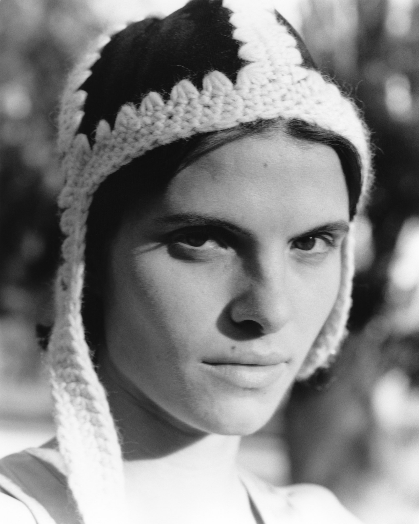 a model looks at the camera wearing a knitted hat