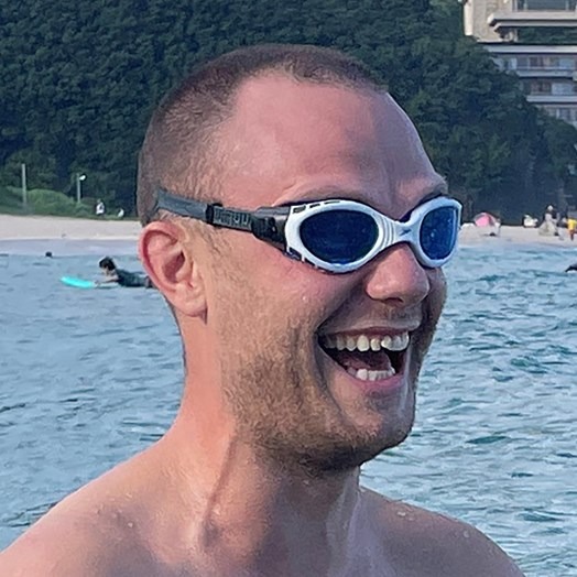 a man in goggles smiling