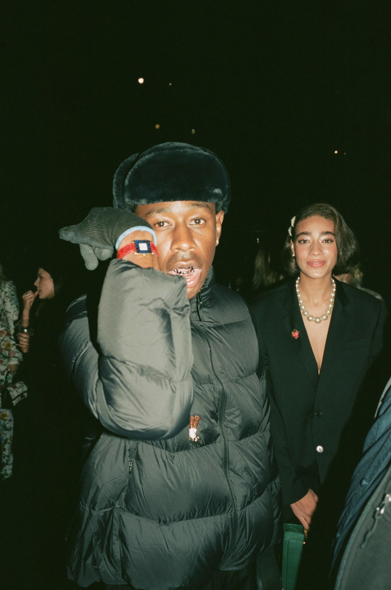 tyler the creator shows off his red wristwatch at a LACMA party