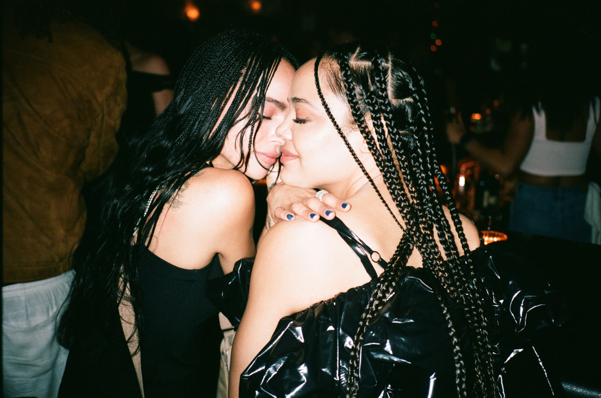 zoe kravitz and tessa thompson pose with their faces close together, wearing all black