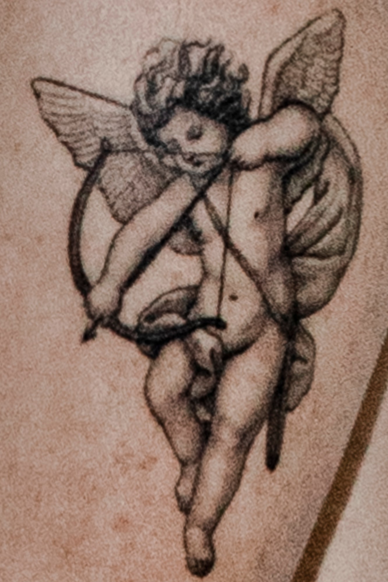 A close up of a cupid tattoo.