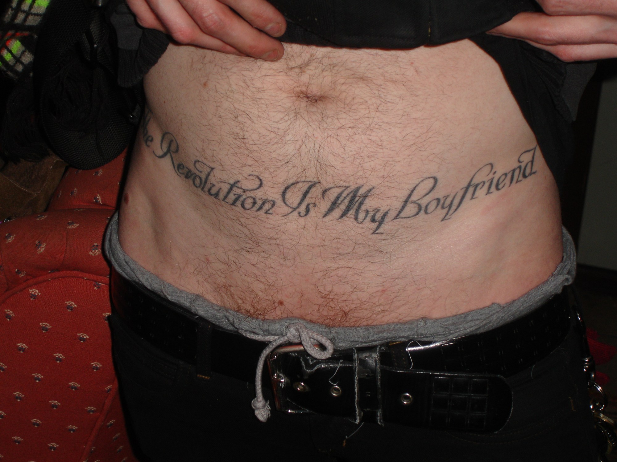 a hairy tummy with the words the revolution is my boyfriends tattooed on it