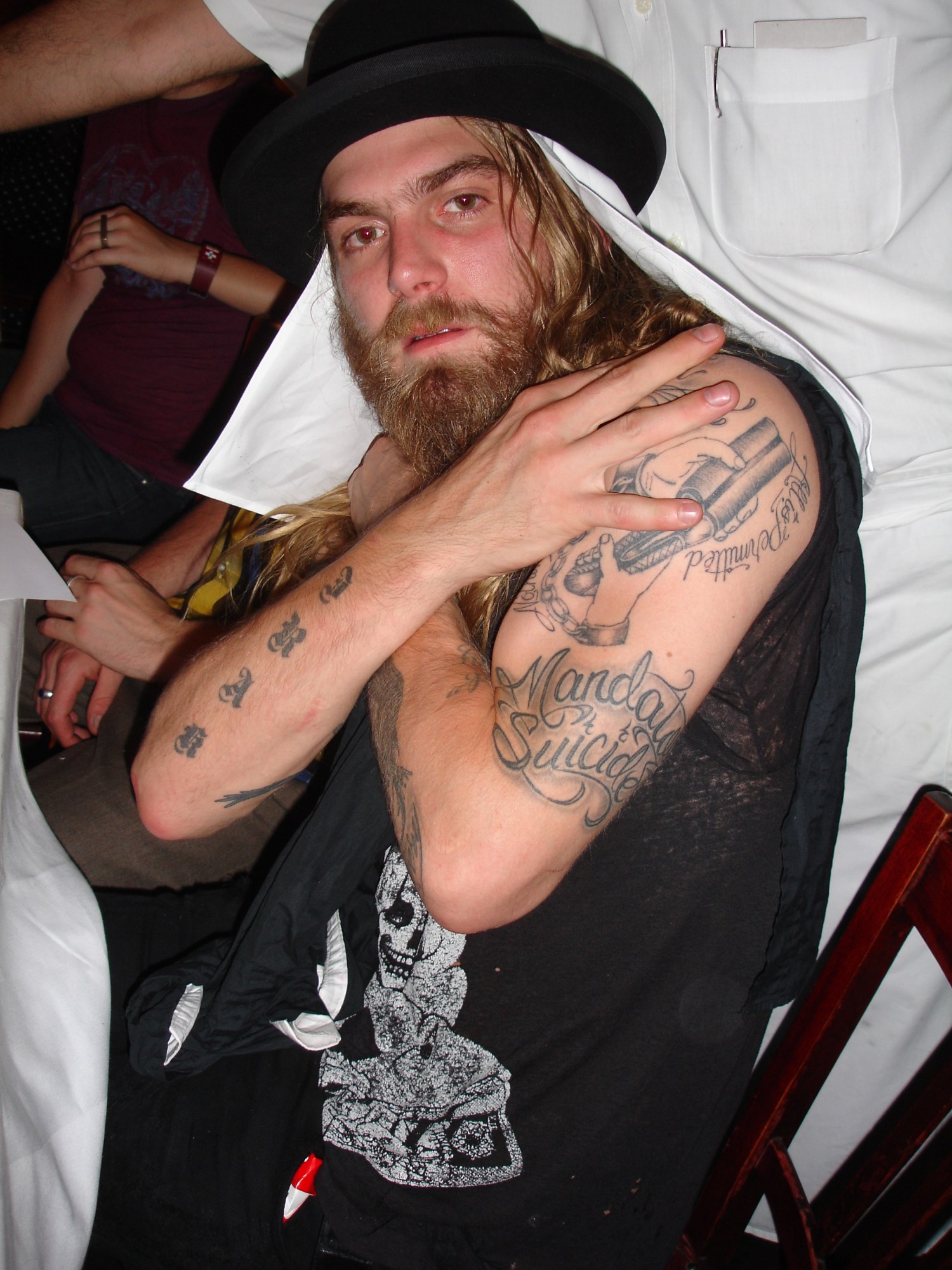 the artist dash snow, tattooed with long blonde hair and a beard