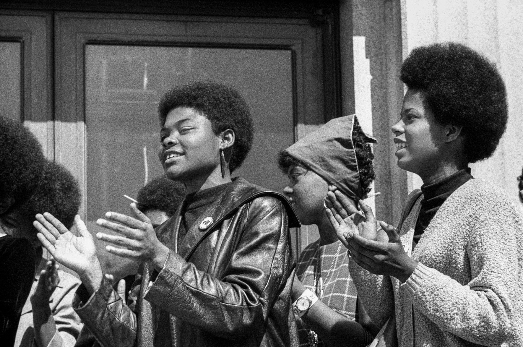 black-and-white photo of the women of the black panther party cheering