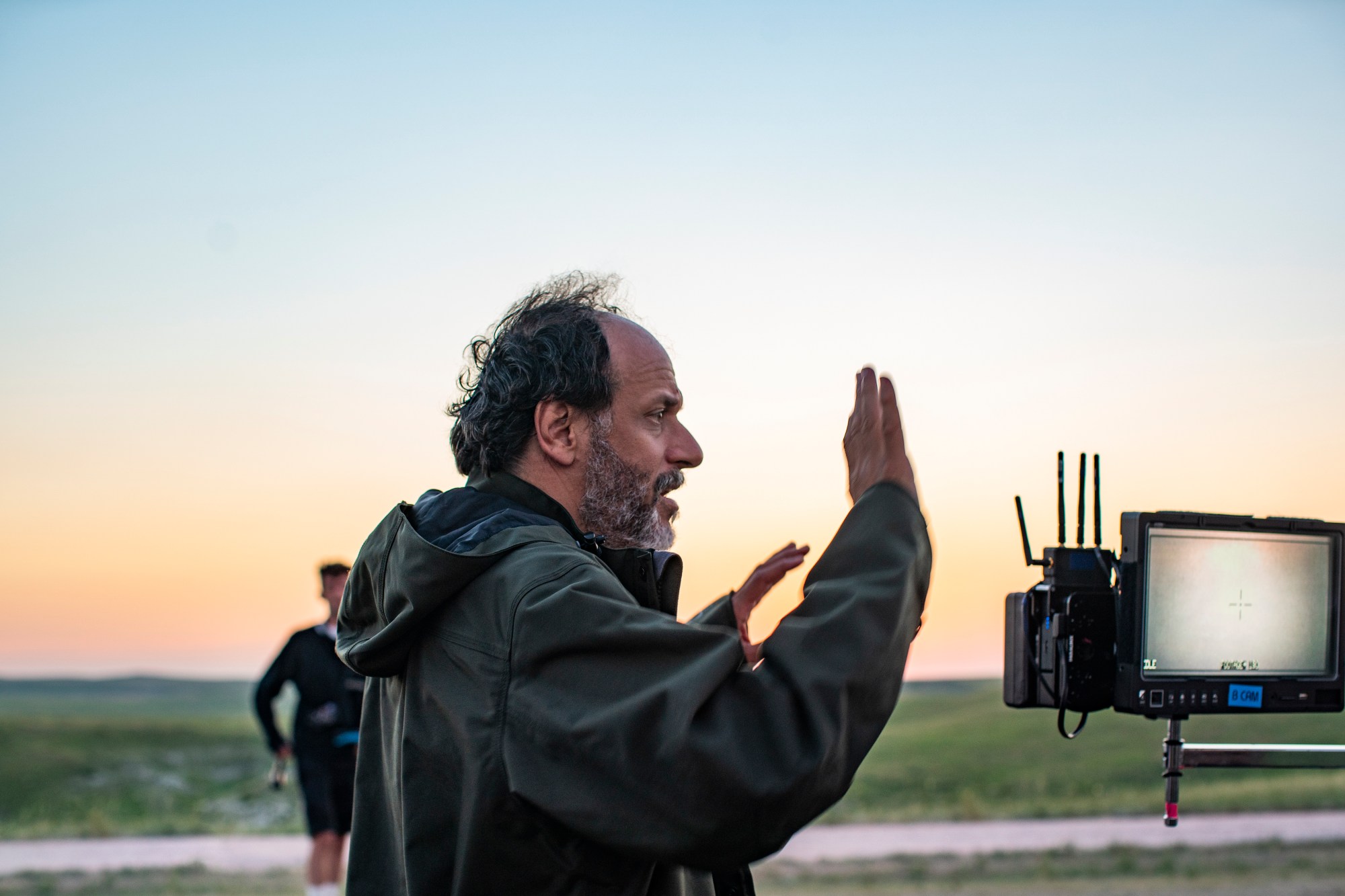 luca guadagnino directing in a field behind the scenes