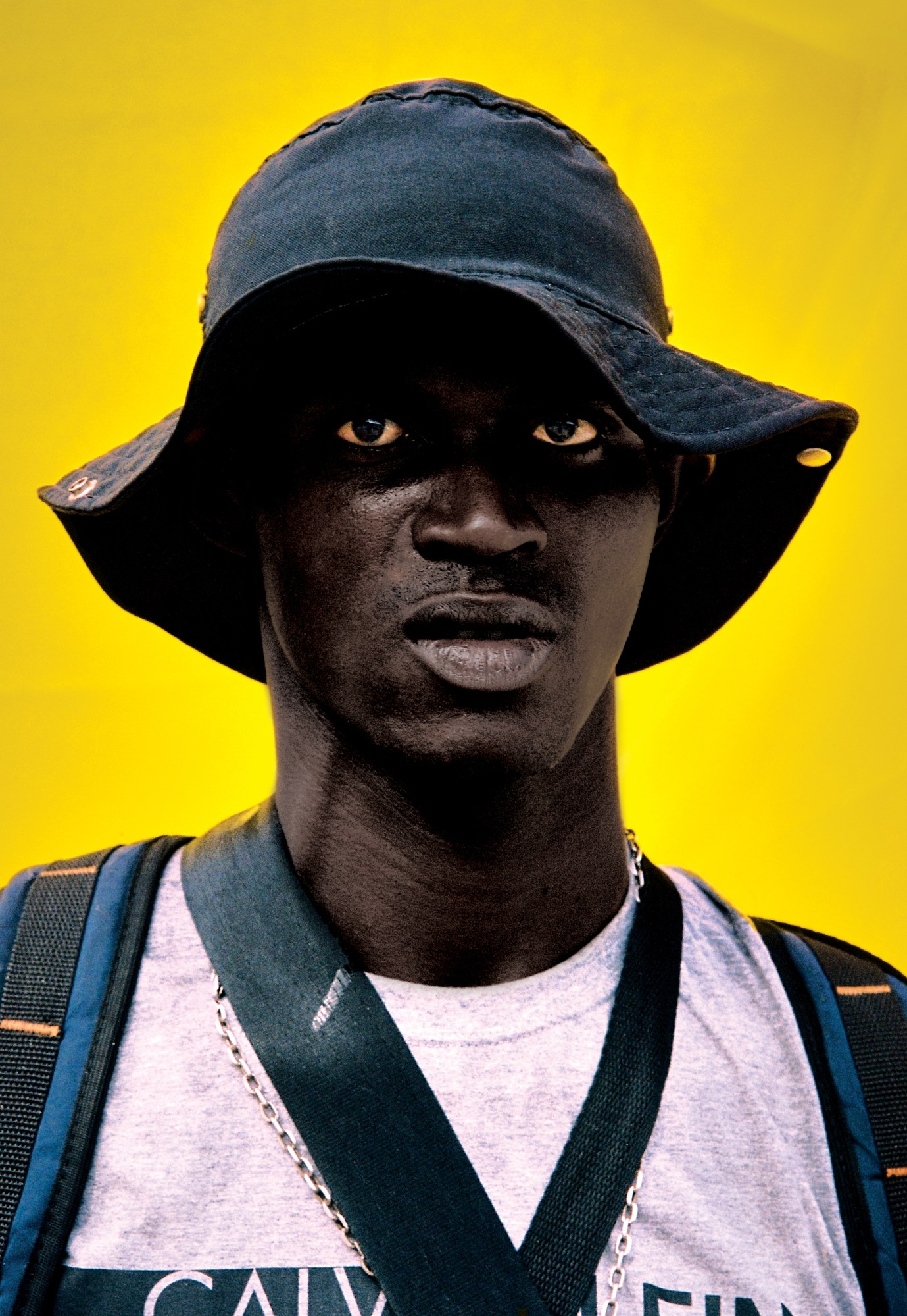 a man in a bucket hat gazing into the camera