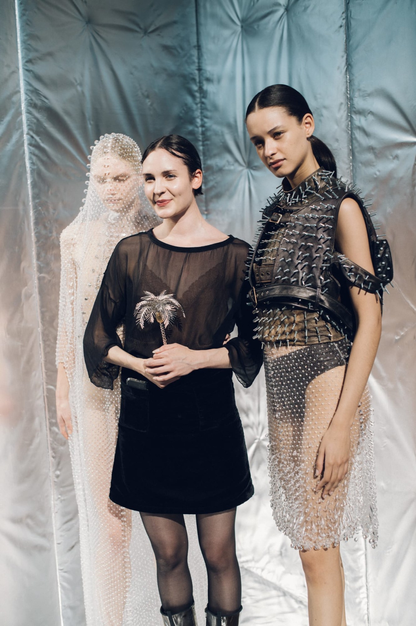 A girl holding an award and another girl in a gauzy dress stood next to her