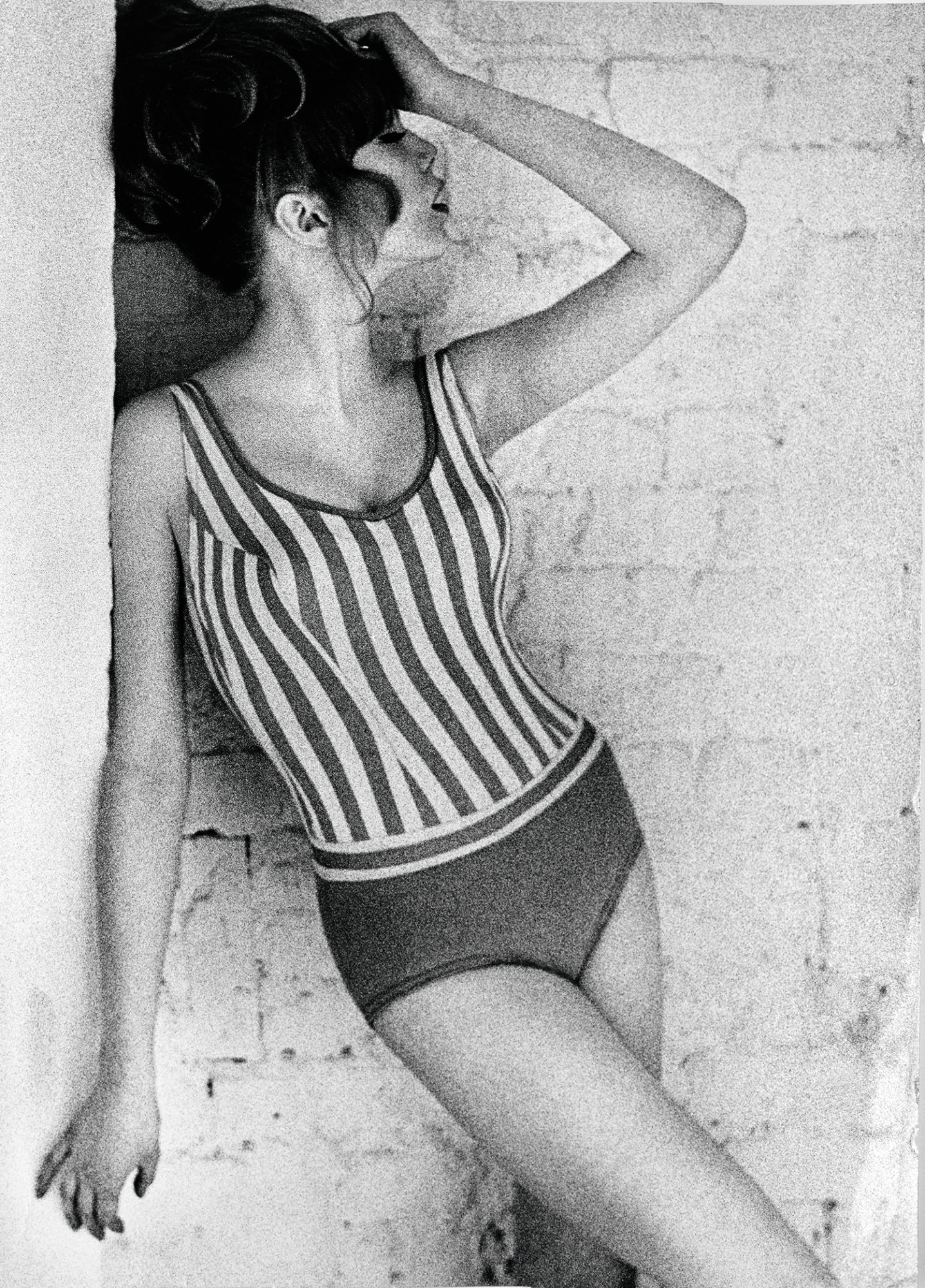 black-and-white photo of pattie boyd in a striped swimsuit