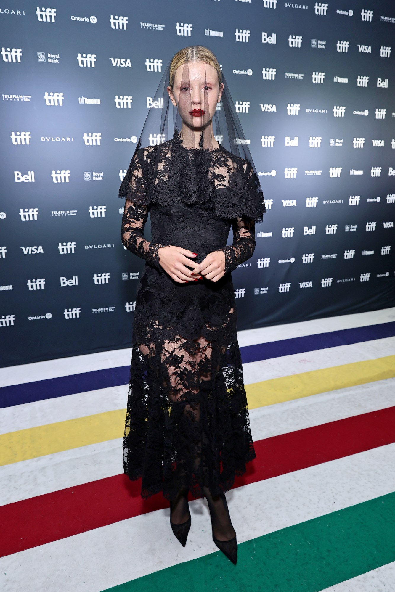 mia goth in a black lace dress and veil at toronto film festival 2022