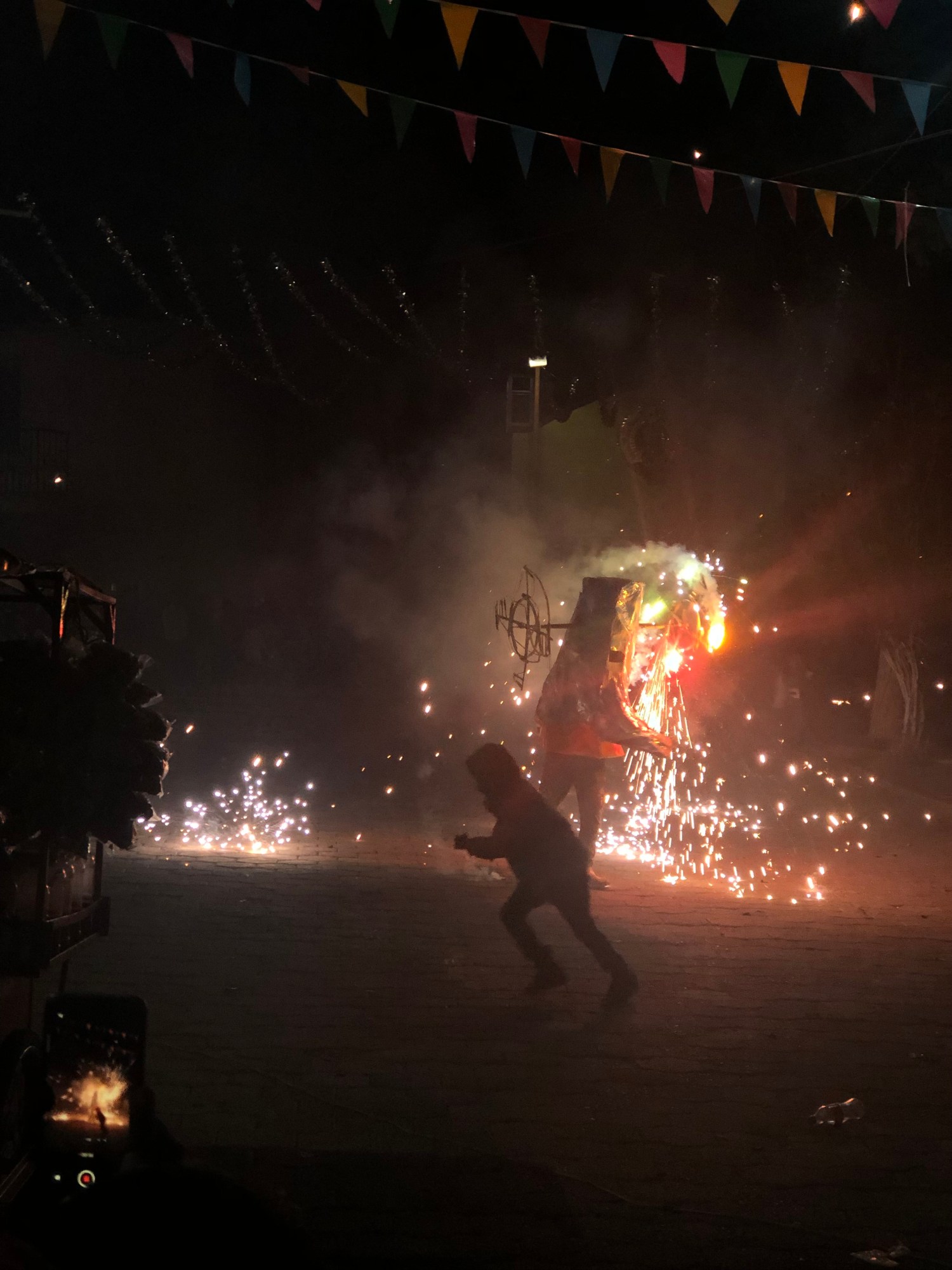 a child runs from fireworks during the celebration of saint jude thaddeus