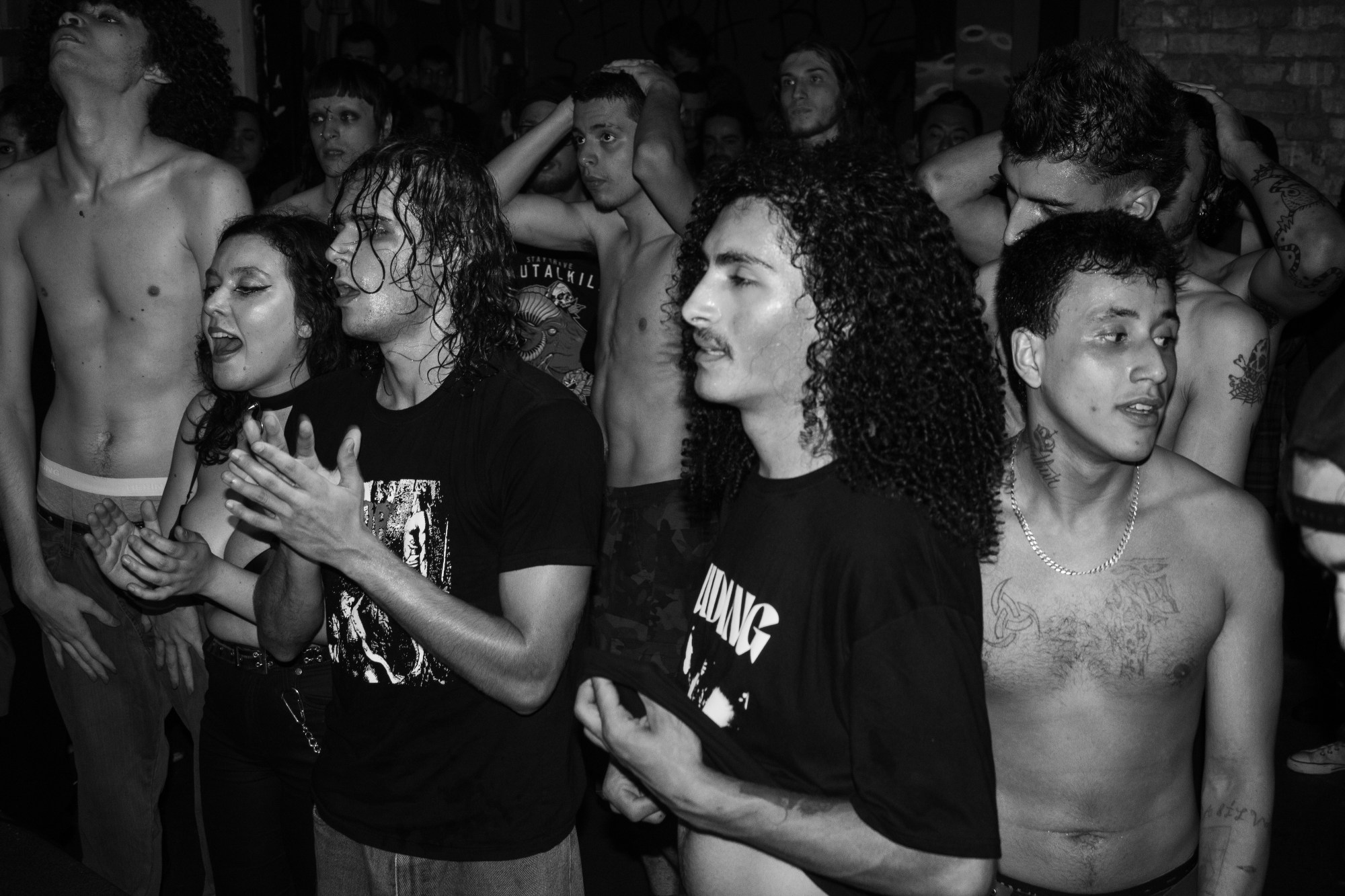 black-and-white photo of fans in a mosh pit