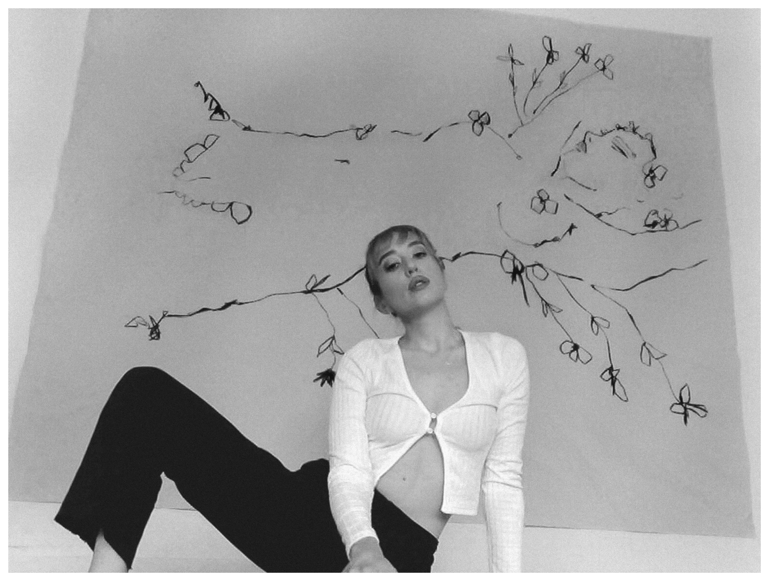 a portrait of natalie krim posing in front of her artwork