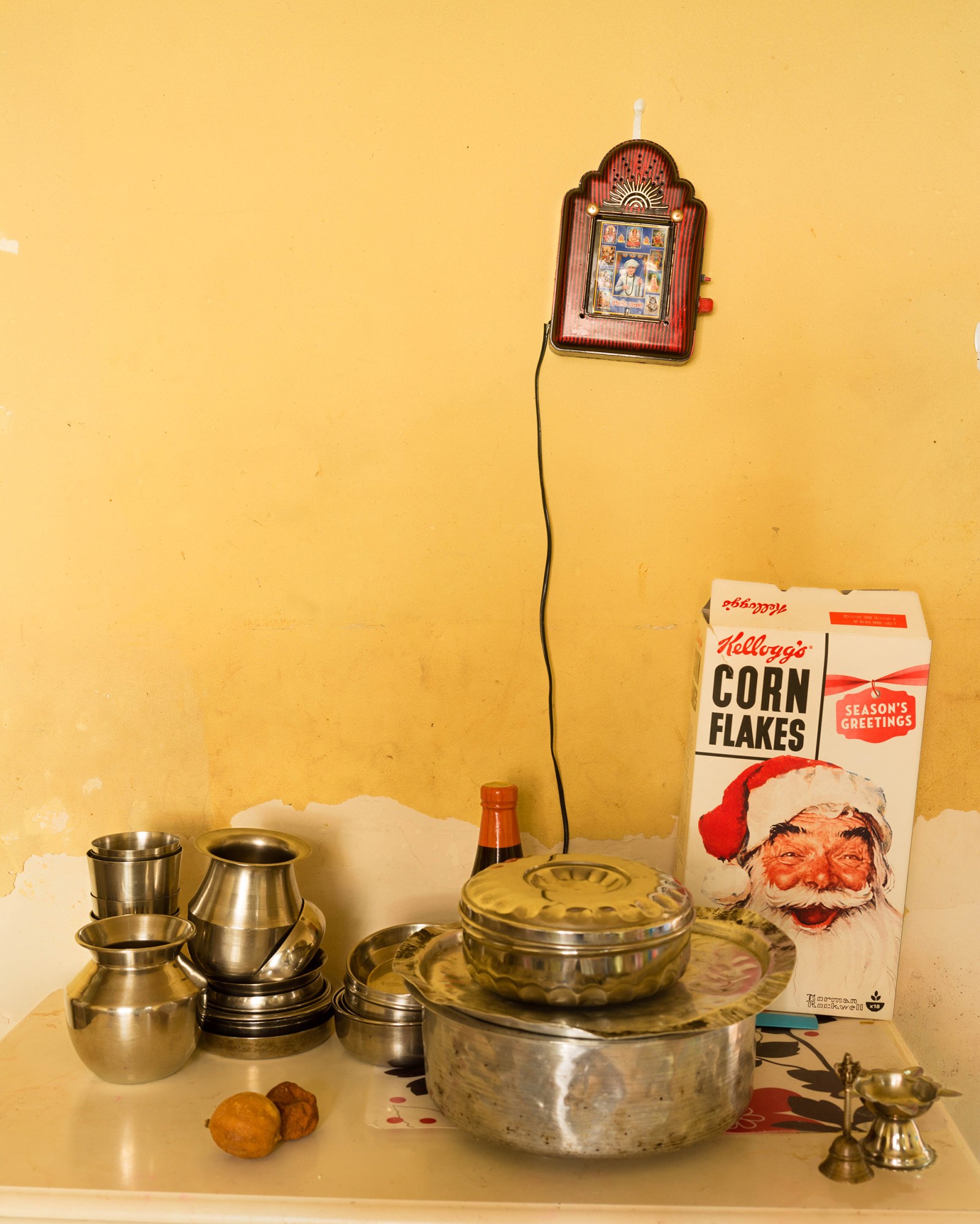 a kitchen table covered with steel pots and a box of corn flakes