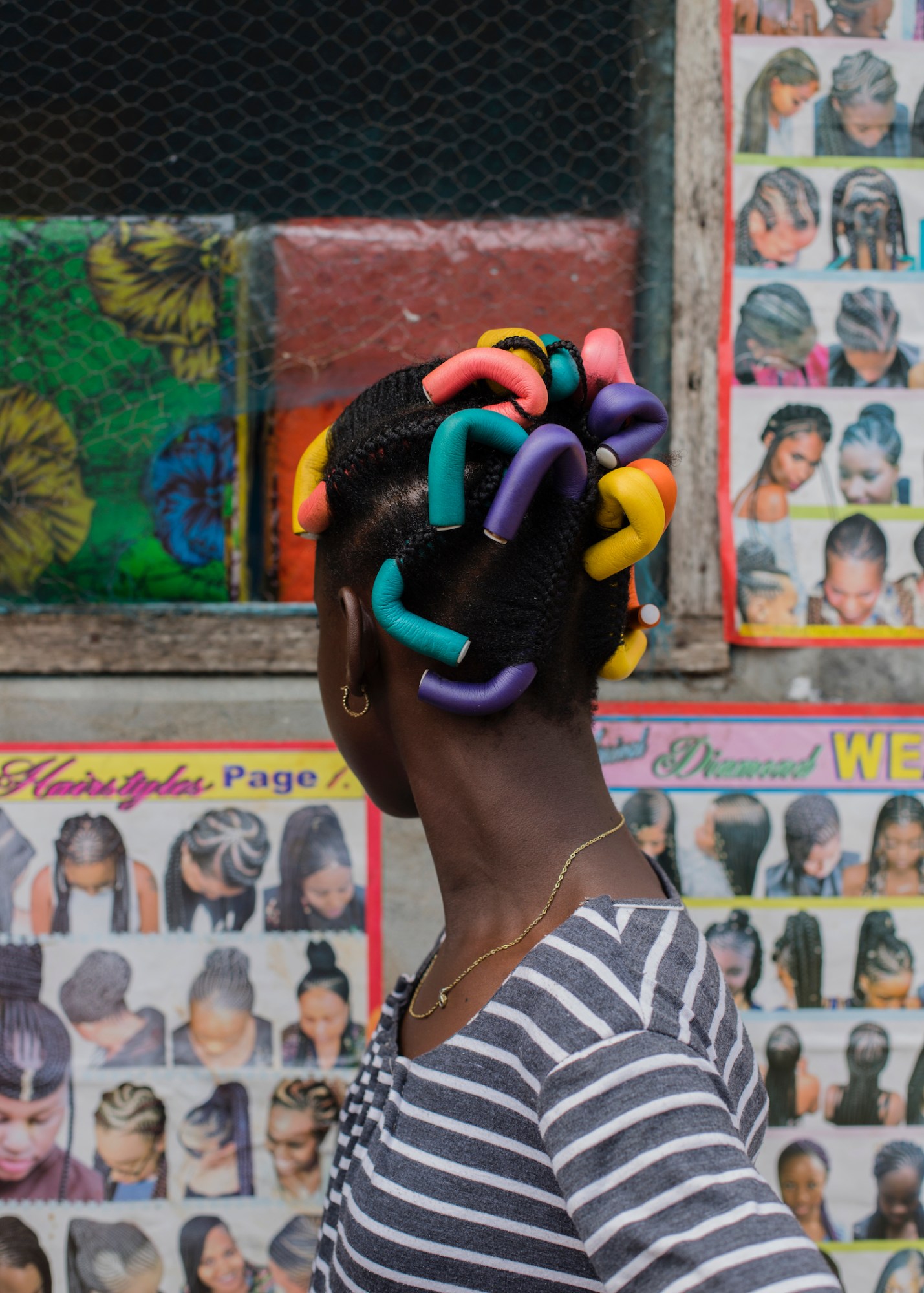 a young girl wearing hair colorful rods