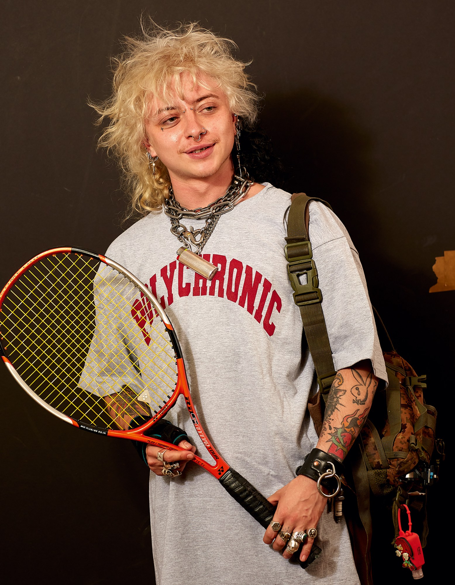 Photograph by Roe Ethridge of a person in a top that says polychromic and holding a badminton racket, featured in the book American Polychronic