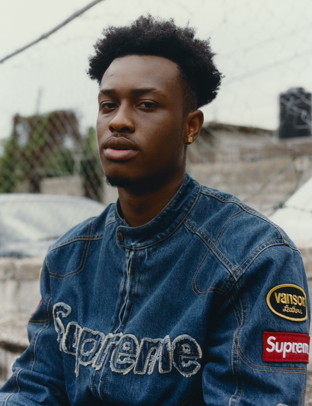 DJ Mac in a supreme denim jacket photographed by Jeano Edwards for i-D’s The Royalty Issue, no. 370, Winter 2022