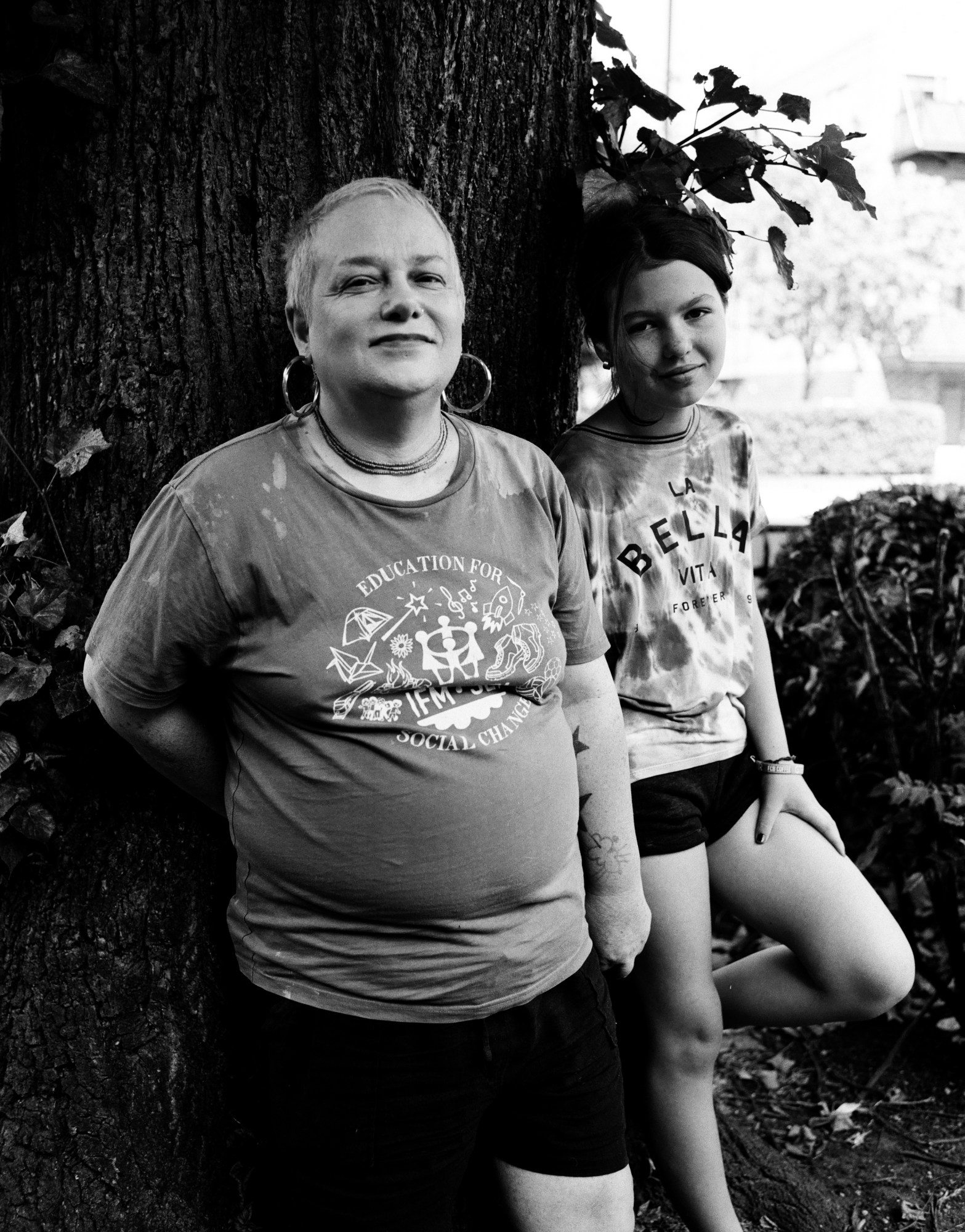 Jaye Ward and their daughter photographed smiling against a tree by Jesse Glazzard for i-D