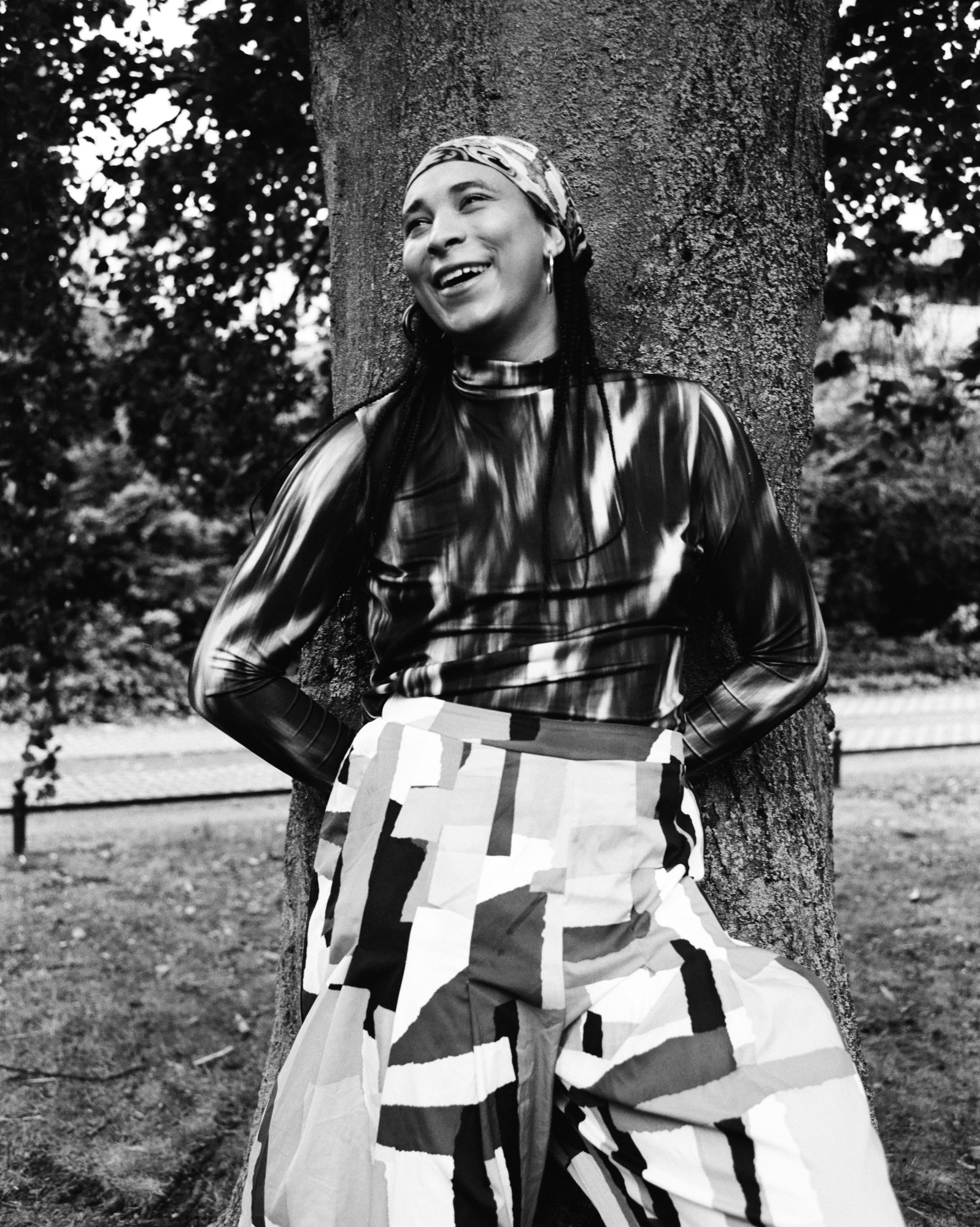 Danielle Brathwaite-Shirley photographed smiling against a tree by Jesse Glazzard for i-D