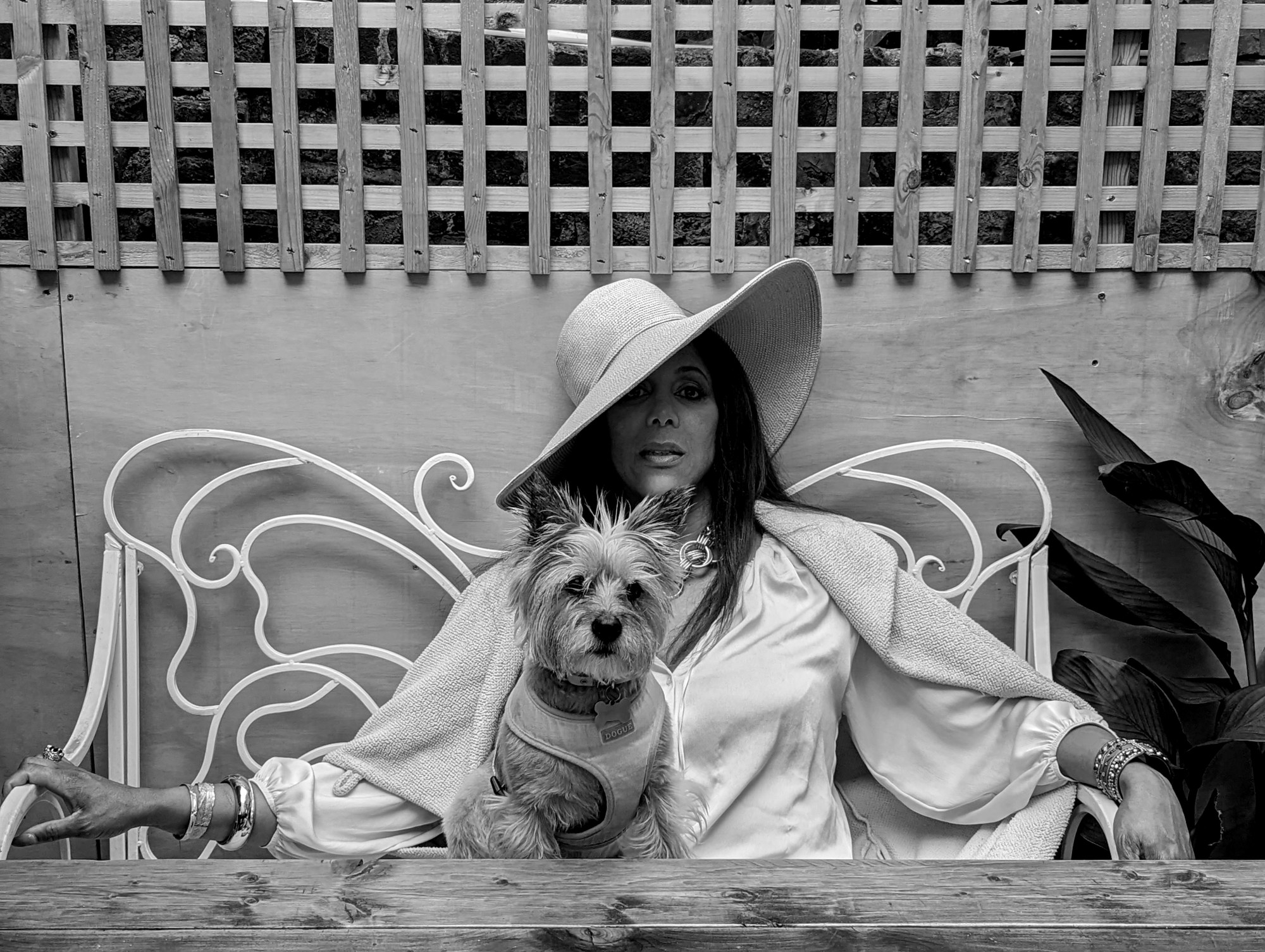 Mzz. Kimberley and her dog photographed sitting on a bench by a table outside by Jesse Glazzard for i-D