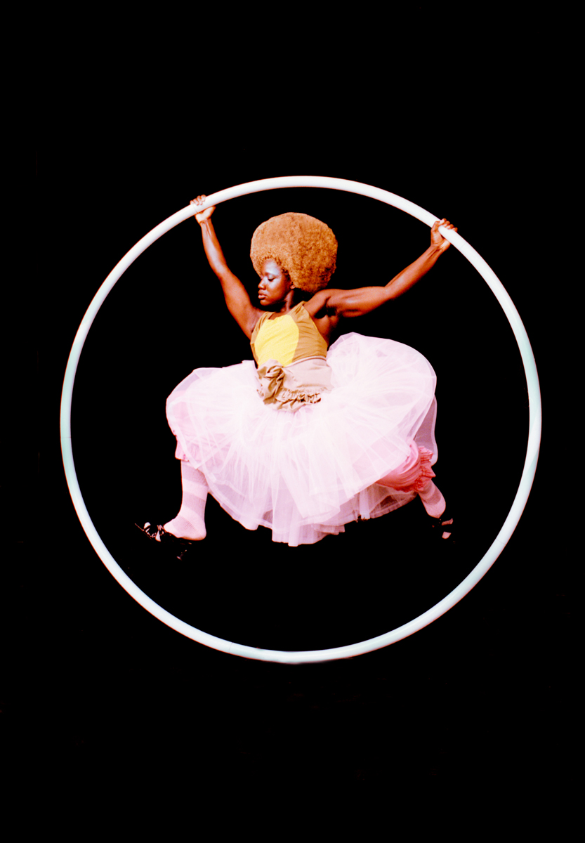 a circus performer mid air in a hoop