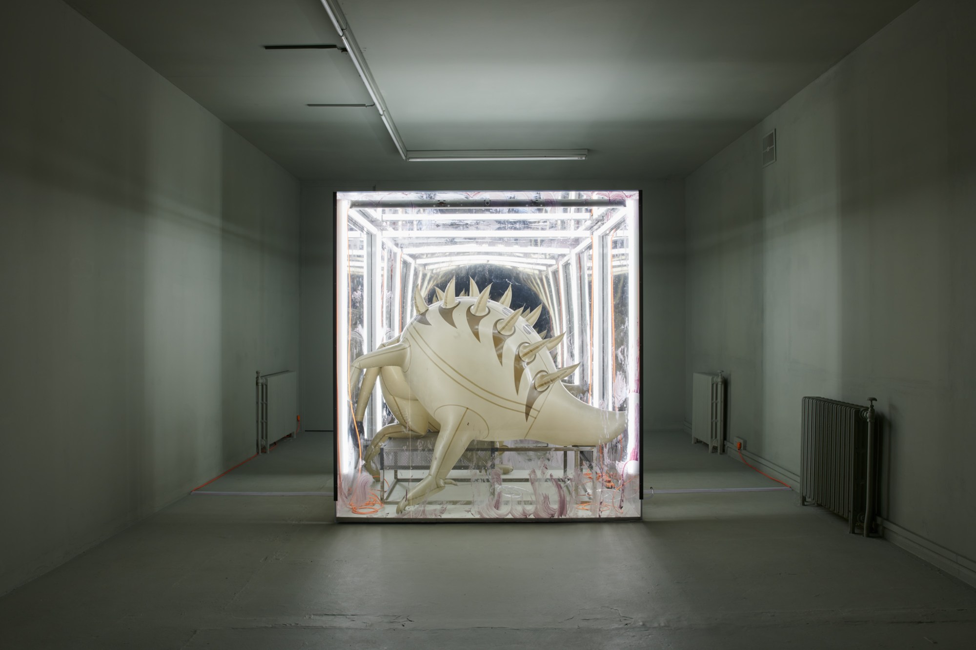 An inflatable monster-like creature in a vitrine