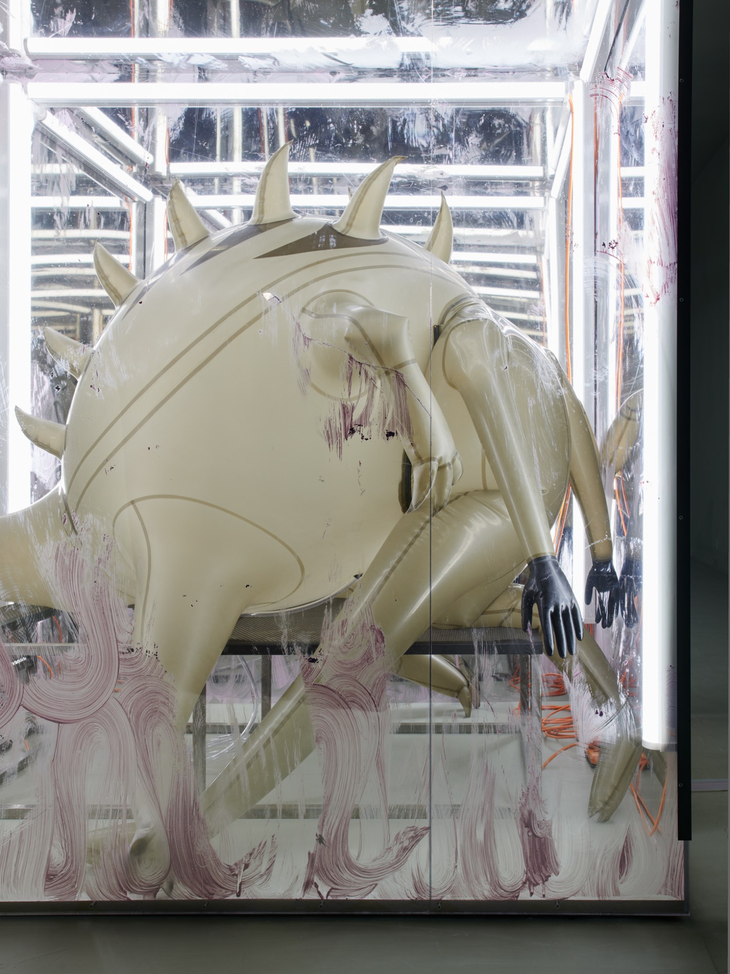 An inflatable monster-like creature in a vitrine