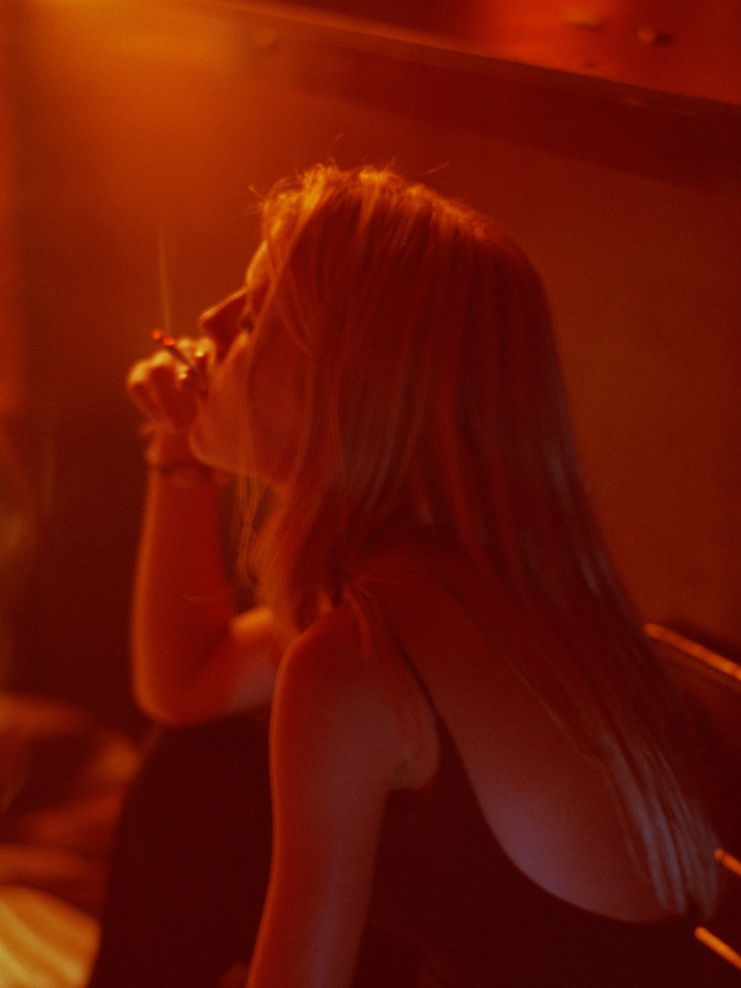 Photograph by Paul Graham of a girl smoking in a nightclub in the 90s from the 1999 book End Of An Age, and featured in i-D’s The Royalty Issue, no. 370, Winter 2022