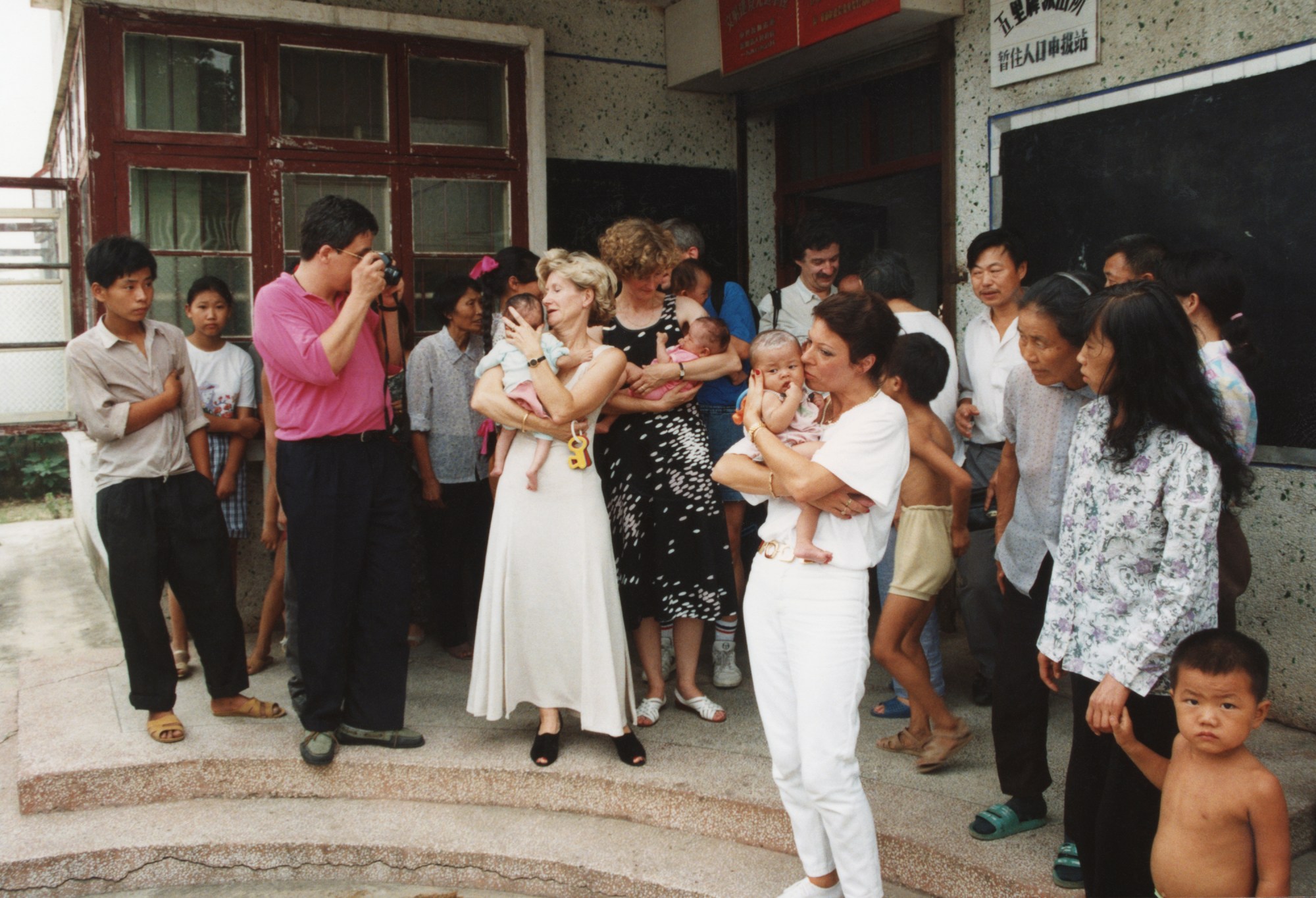 white people holding babies at a chinese orphanage in the early 90s