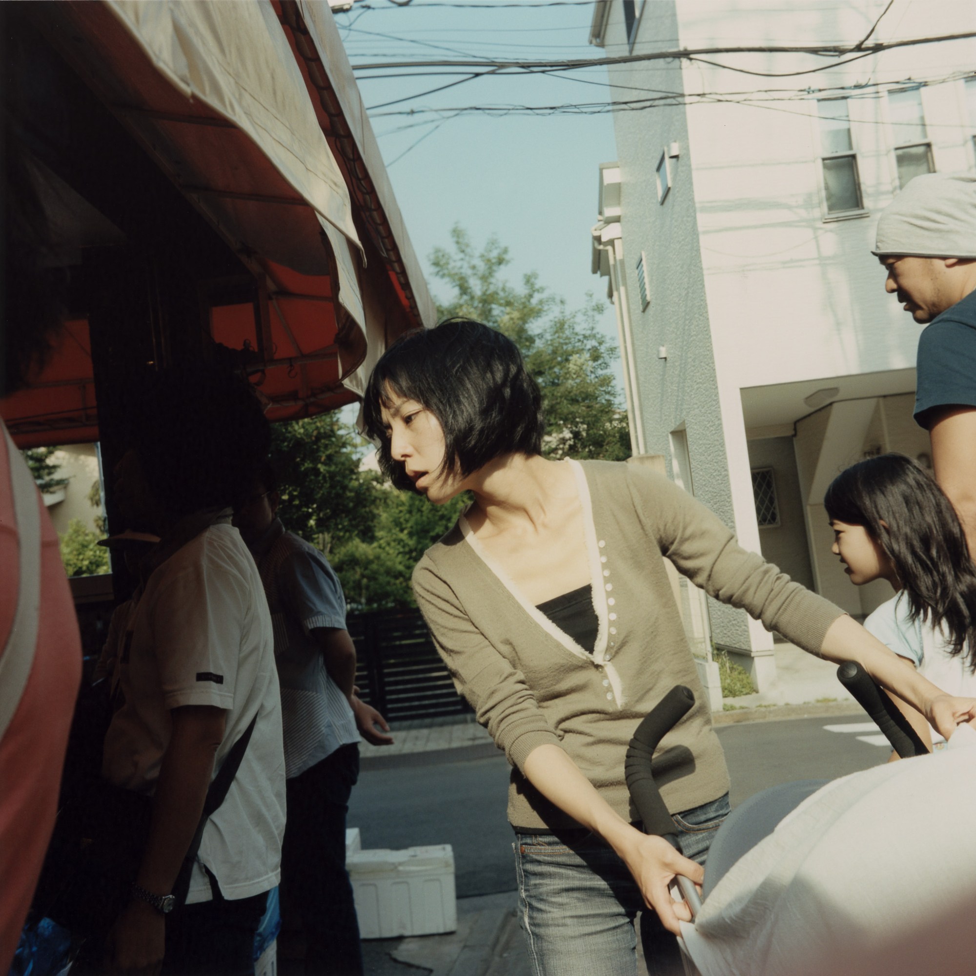 a woman holding a buggy and looking at something