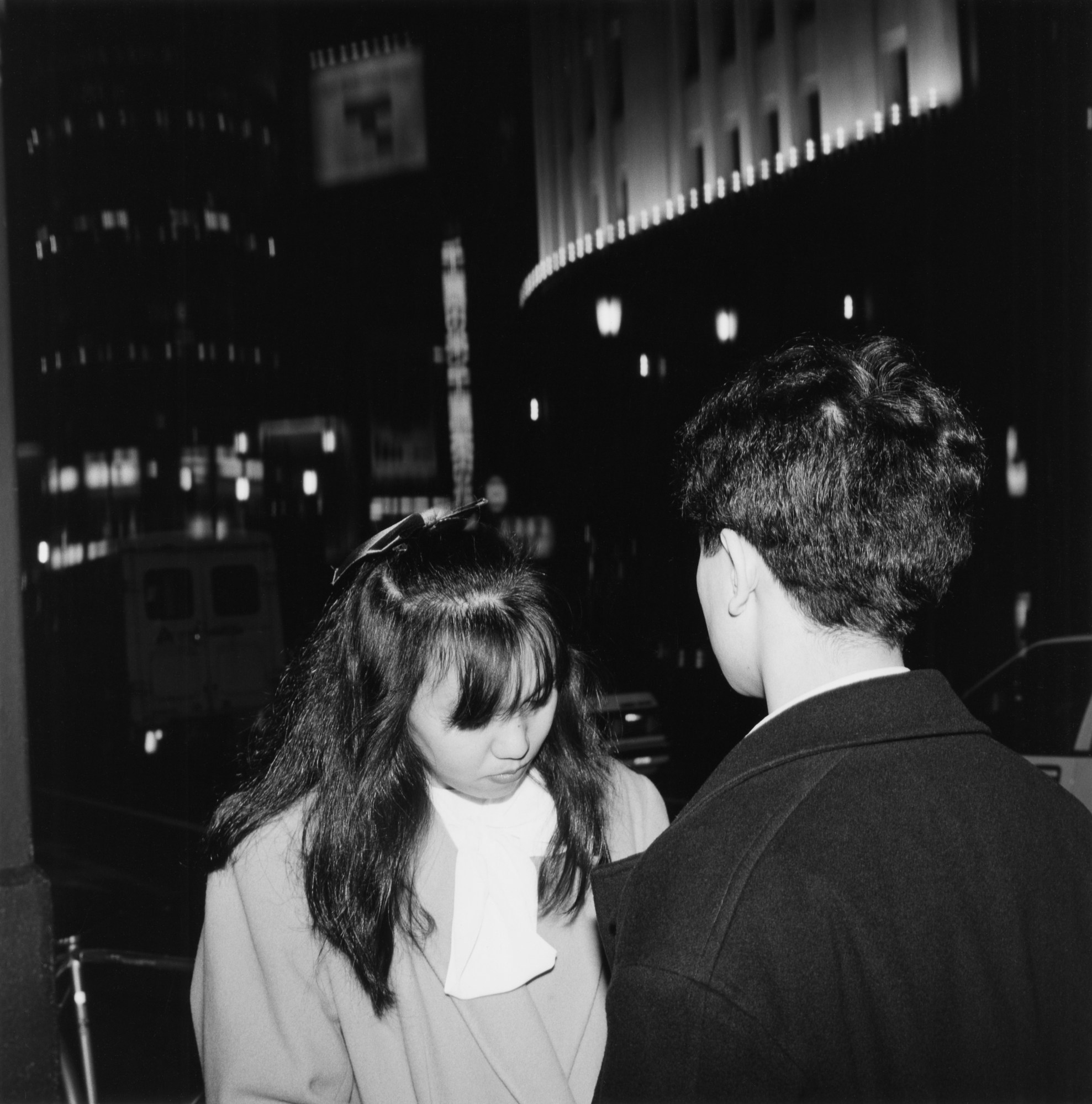 black-and-white image of a young couple on the tokyo street at night on christmas eve