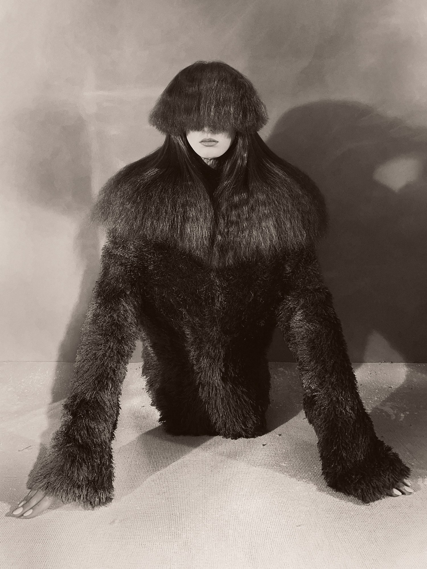 a person kneeling on the floor covered in hair/fur