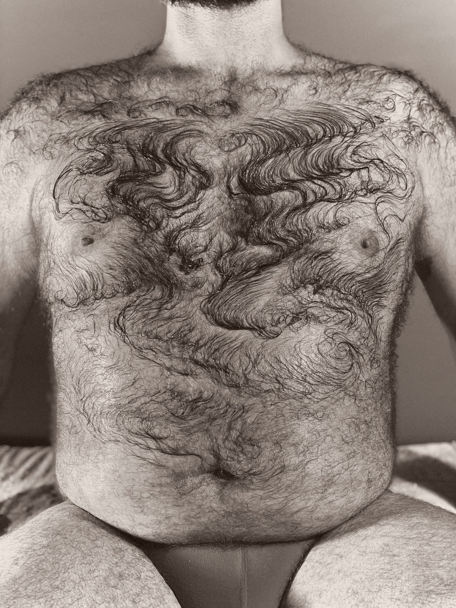 a close up of a hairy chest with a design combed into it around the pecs