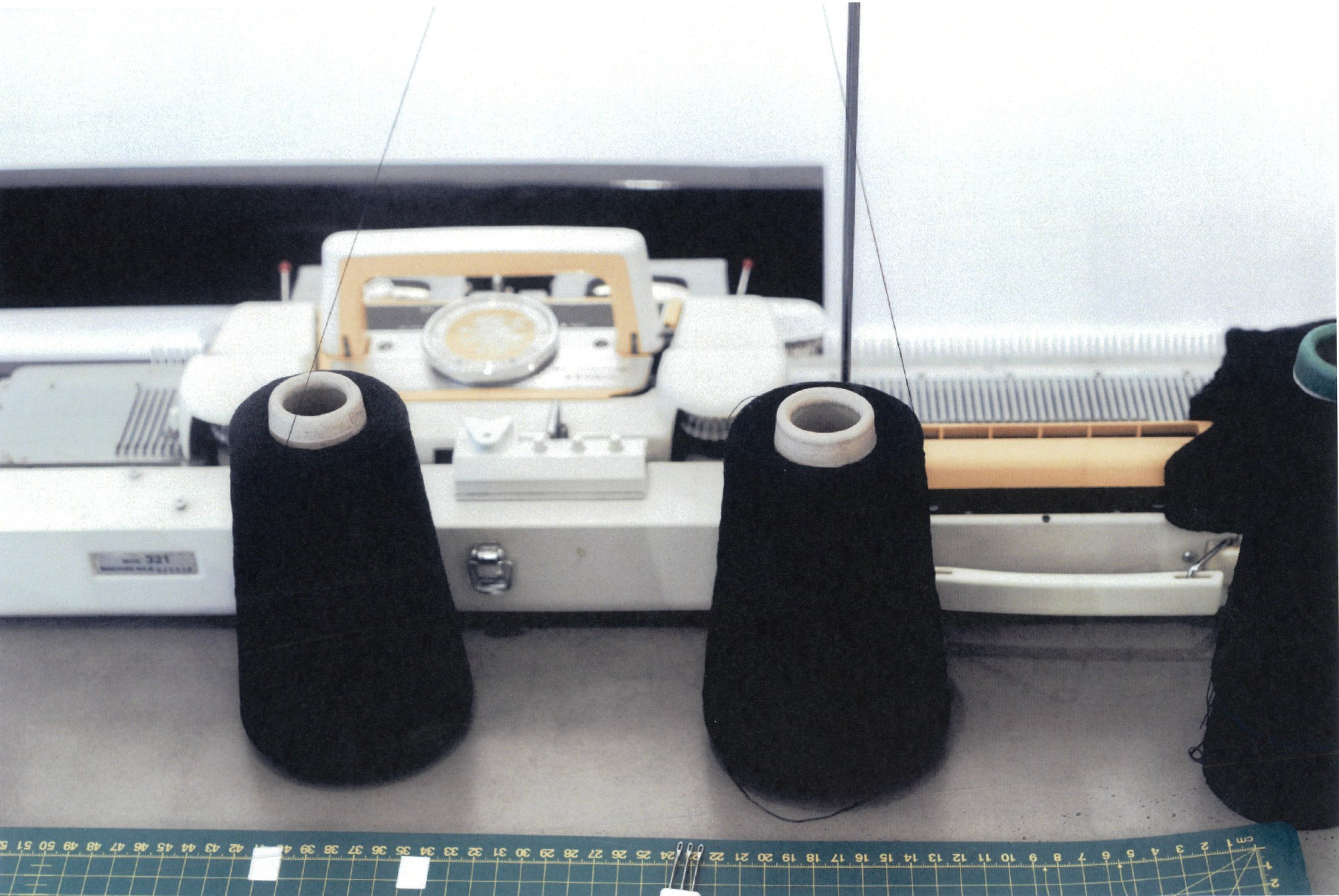 black thread sitting in front of a sewing machine