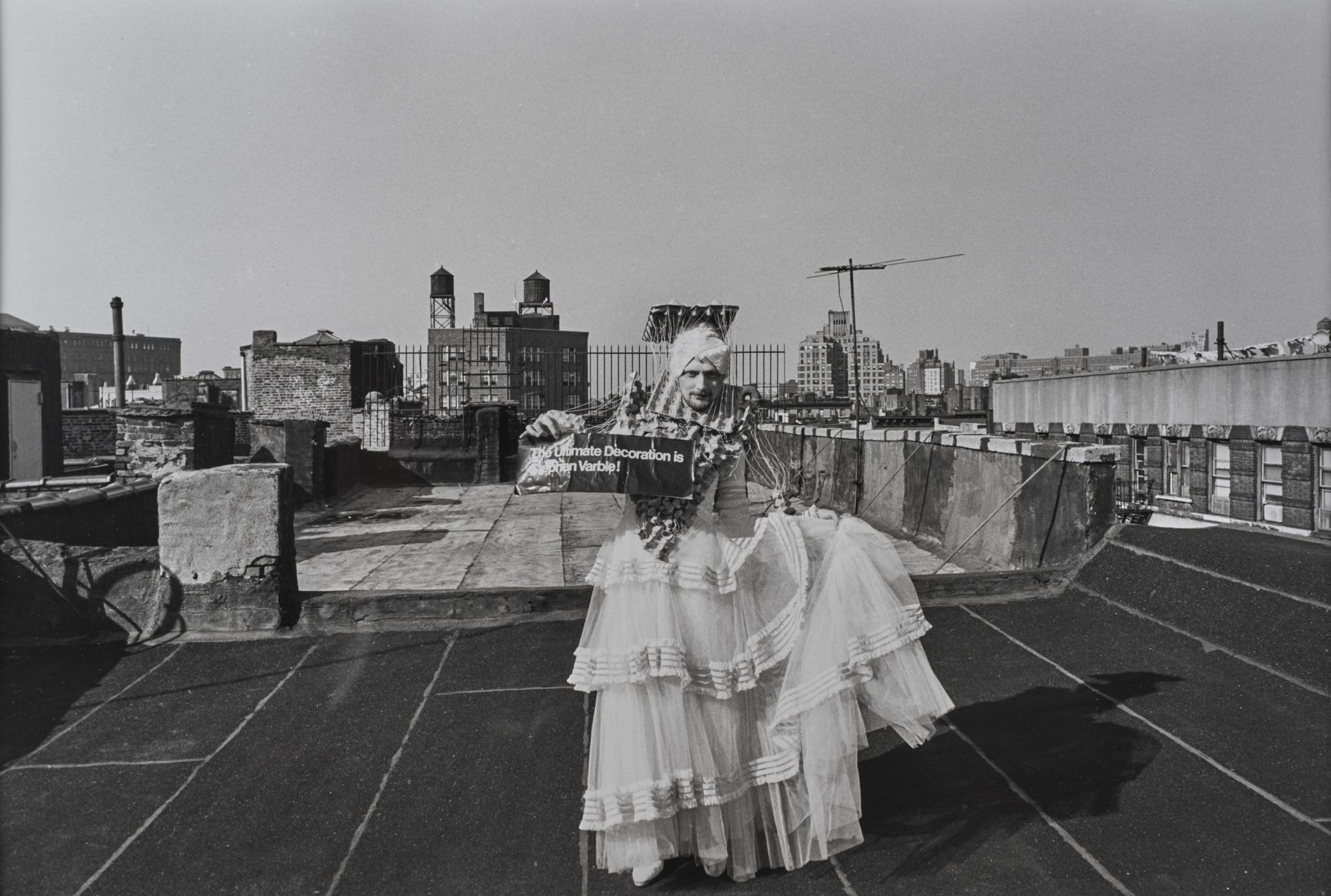 black-and-white image of a man on a roof in new york city