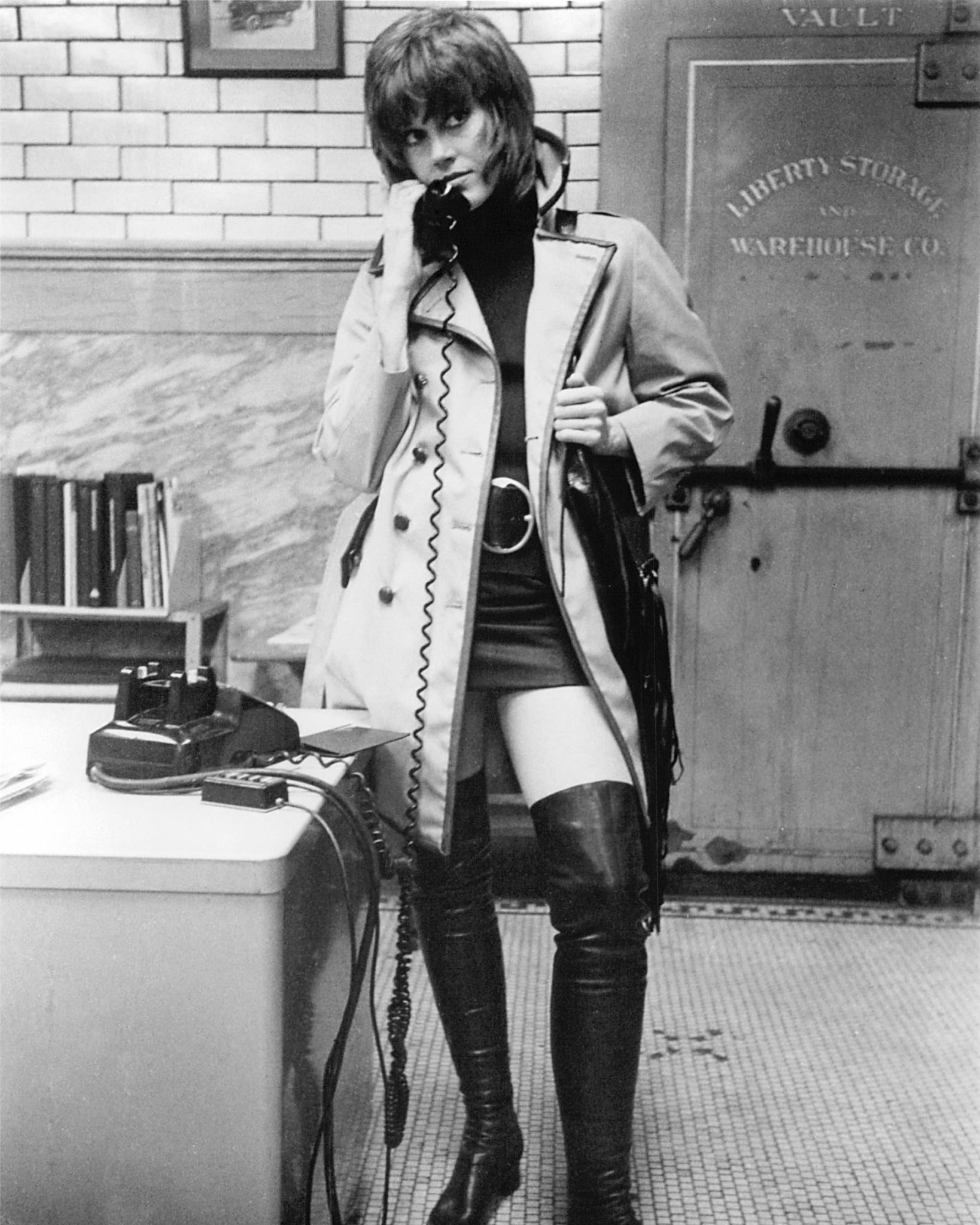 jane fonda on the phone in klute, wearing thigh high boots and a mini skirt 1971