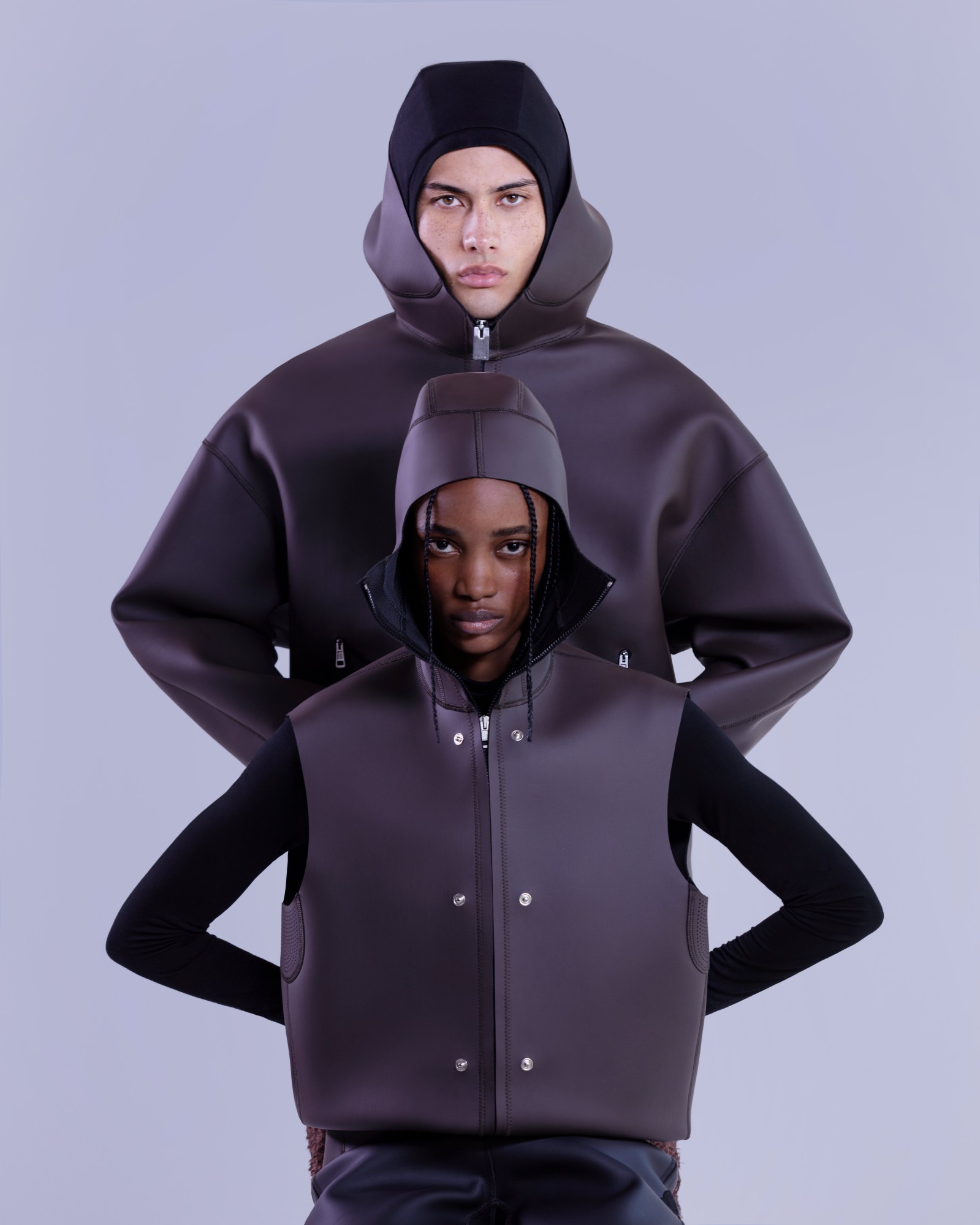 two models wearing hooded neoprene jackets in a studio