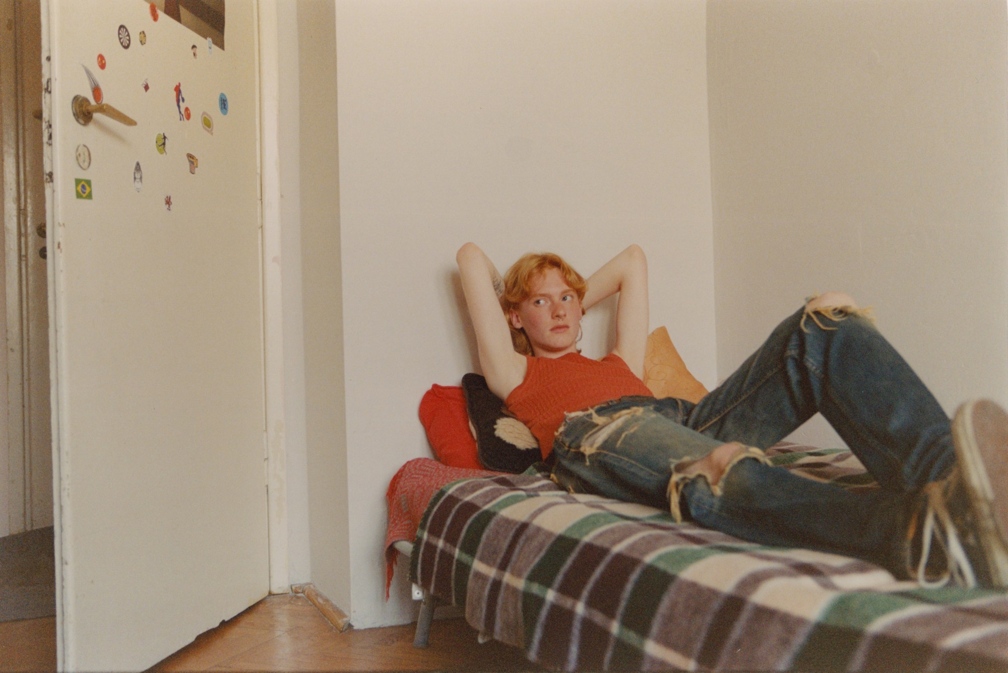 A teenager reclined on a bed