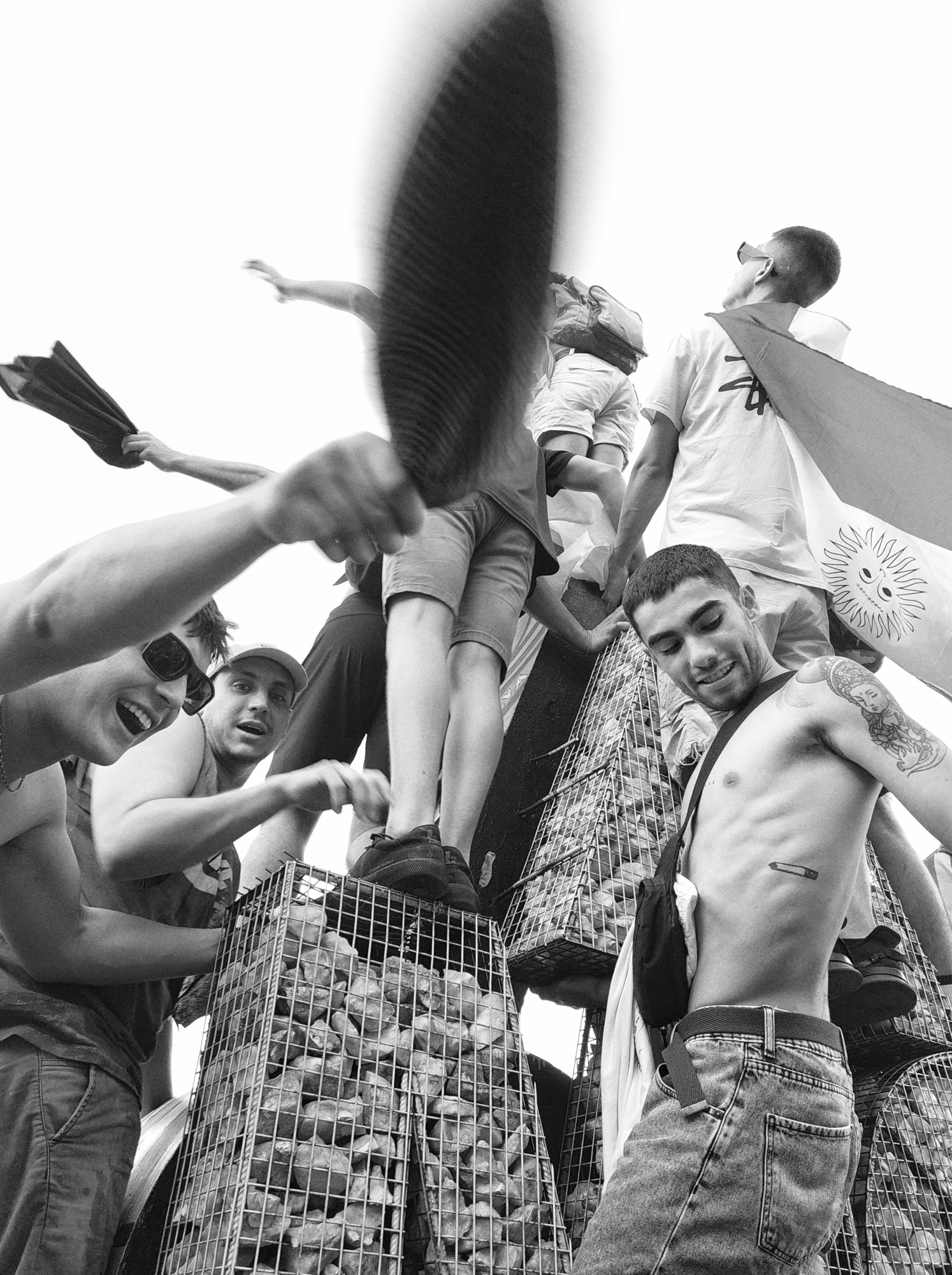 black-and-white image of young men celebrating in the streets when argentina won the world cup