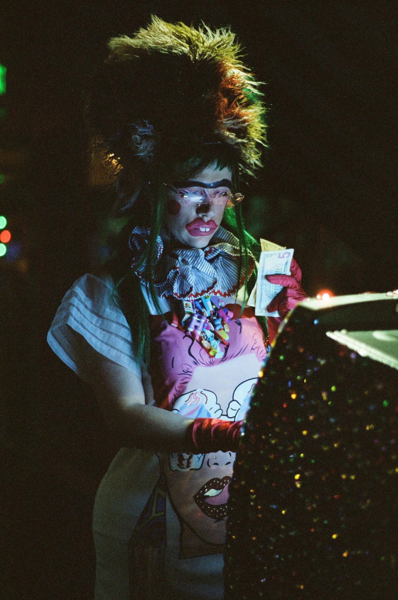 a drag queen taking out money at a bank machine