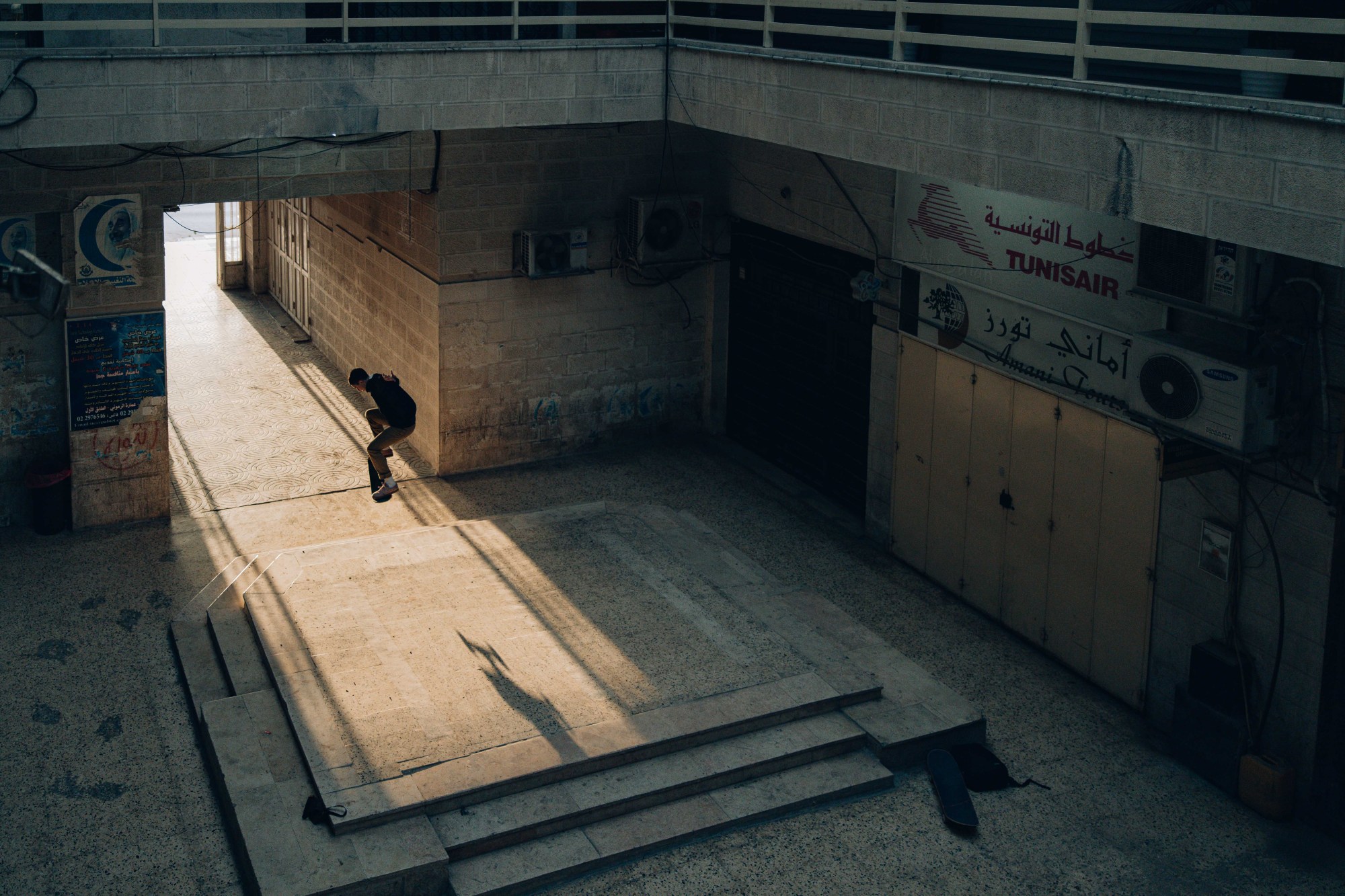 A young man skateboaring in an empty park in Palestine