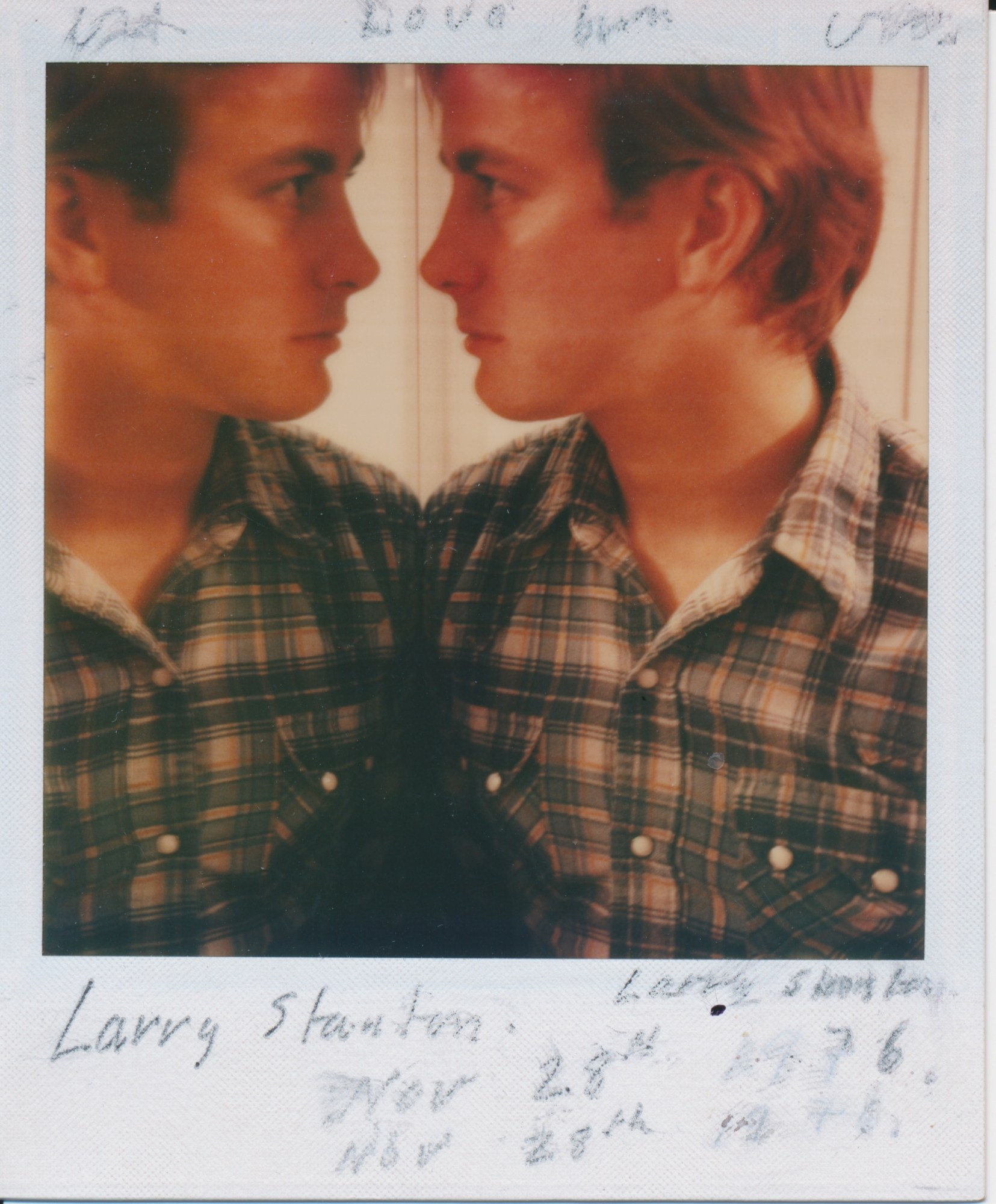 polaroid image of larry stanton looking at himself in a mirror shot by david hockney