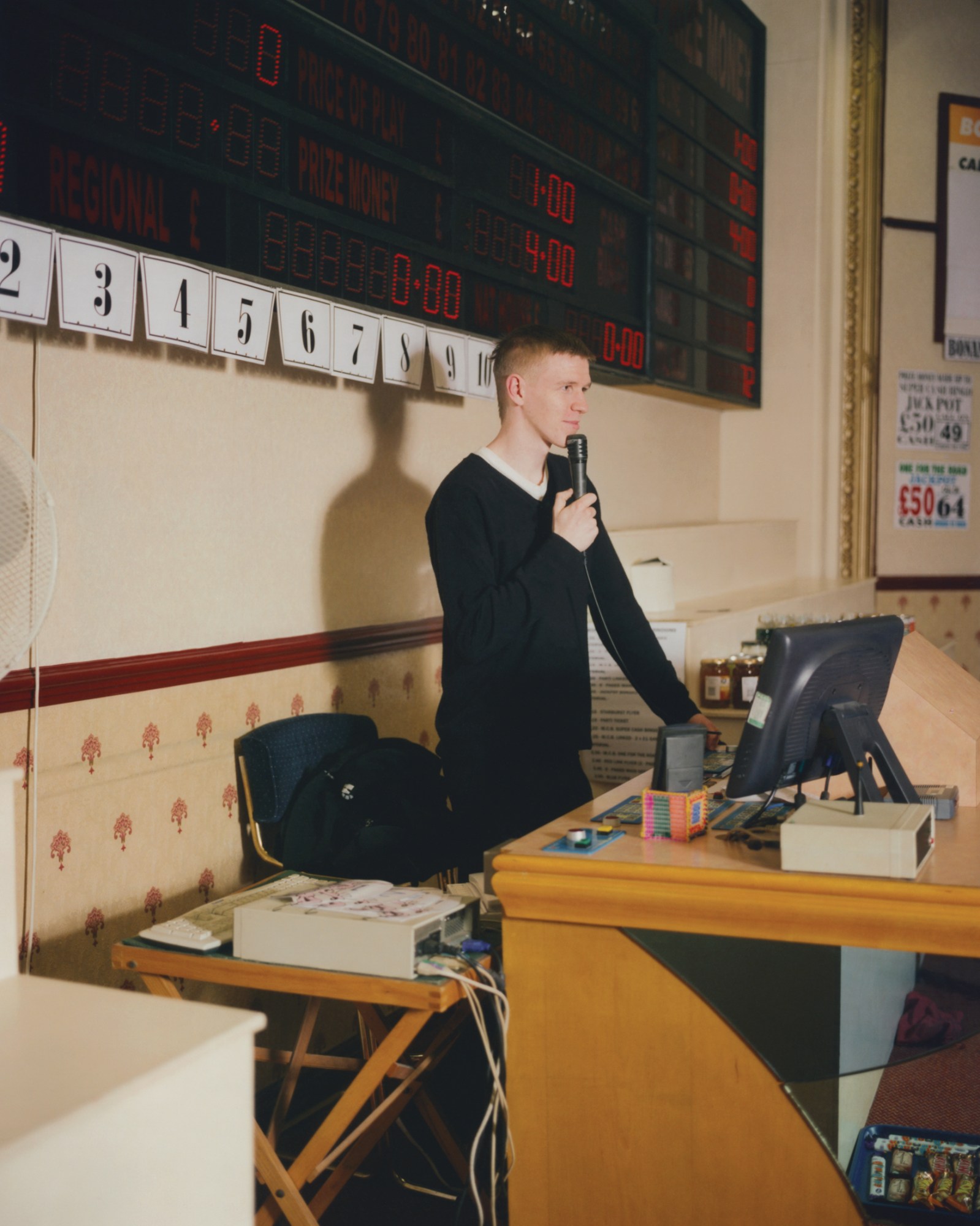 a man holding a microphone at new western bingo hall in leeds