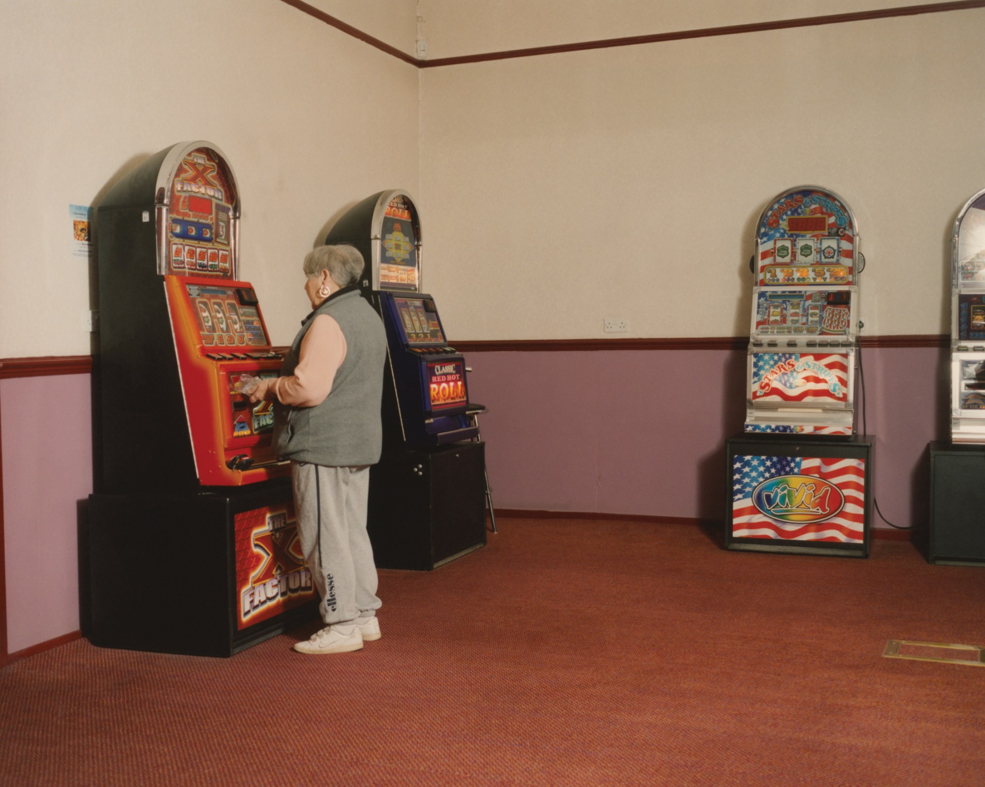 a woman playing a slot machine at new western bingo hall in leeds