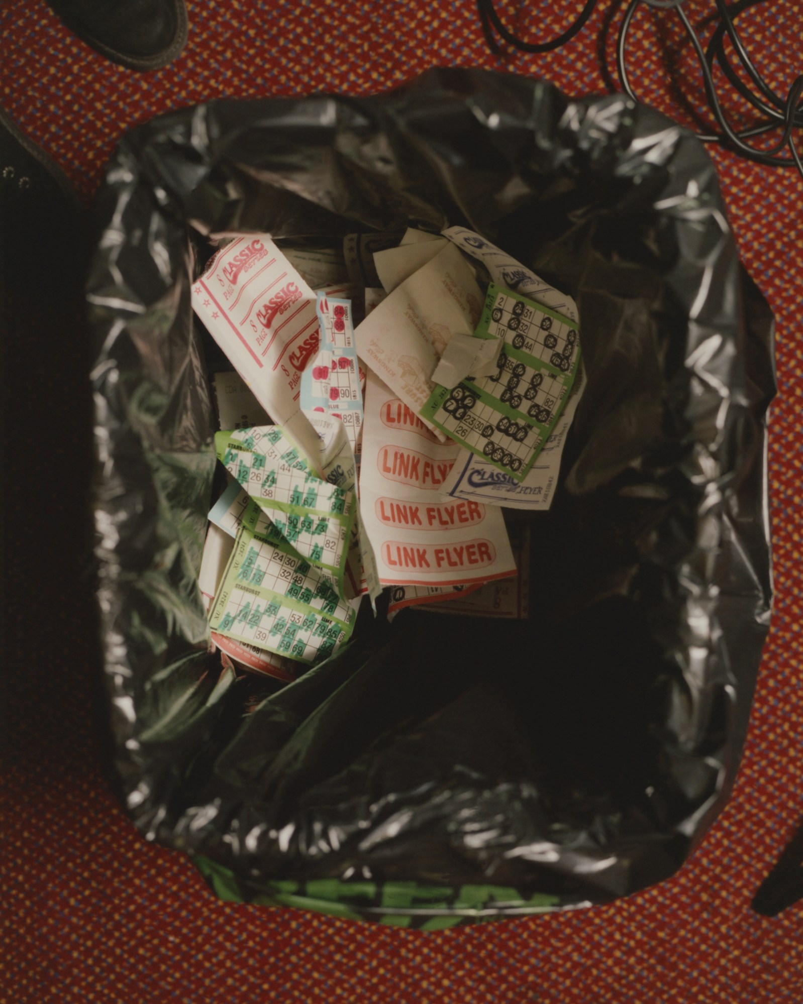 a trash can full of used bingo cards