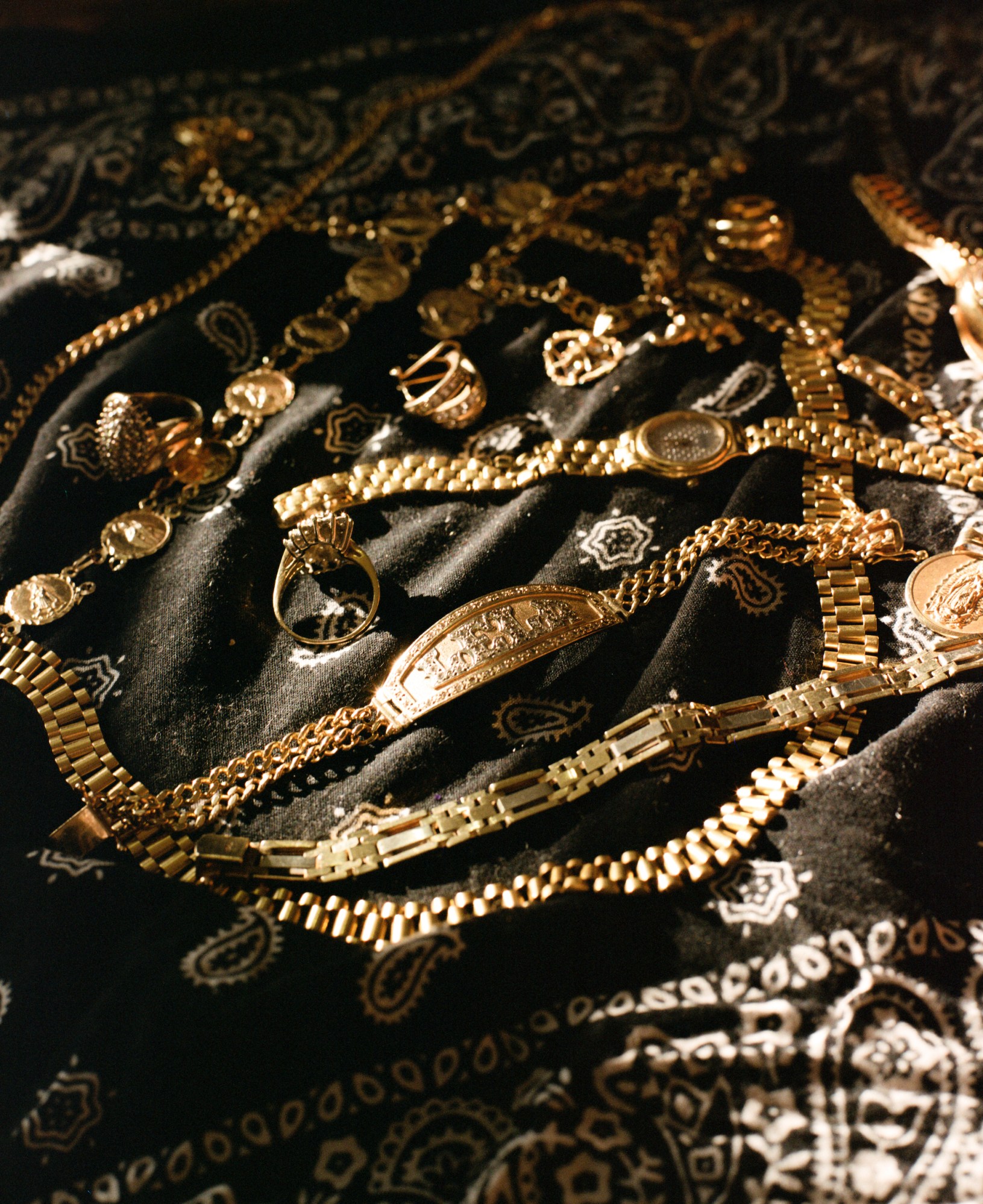 gold chains lying on a black bandana