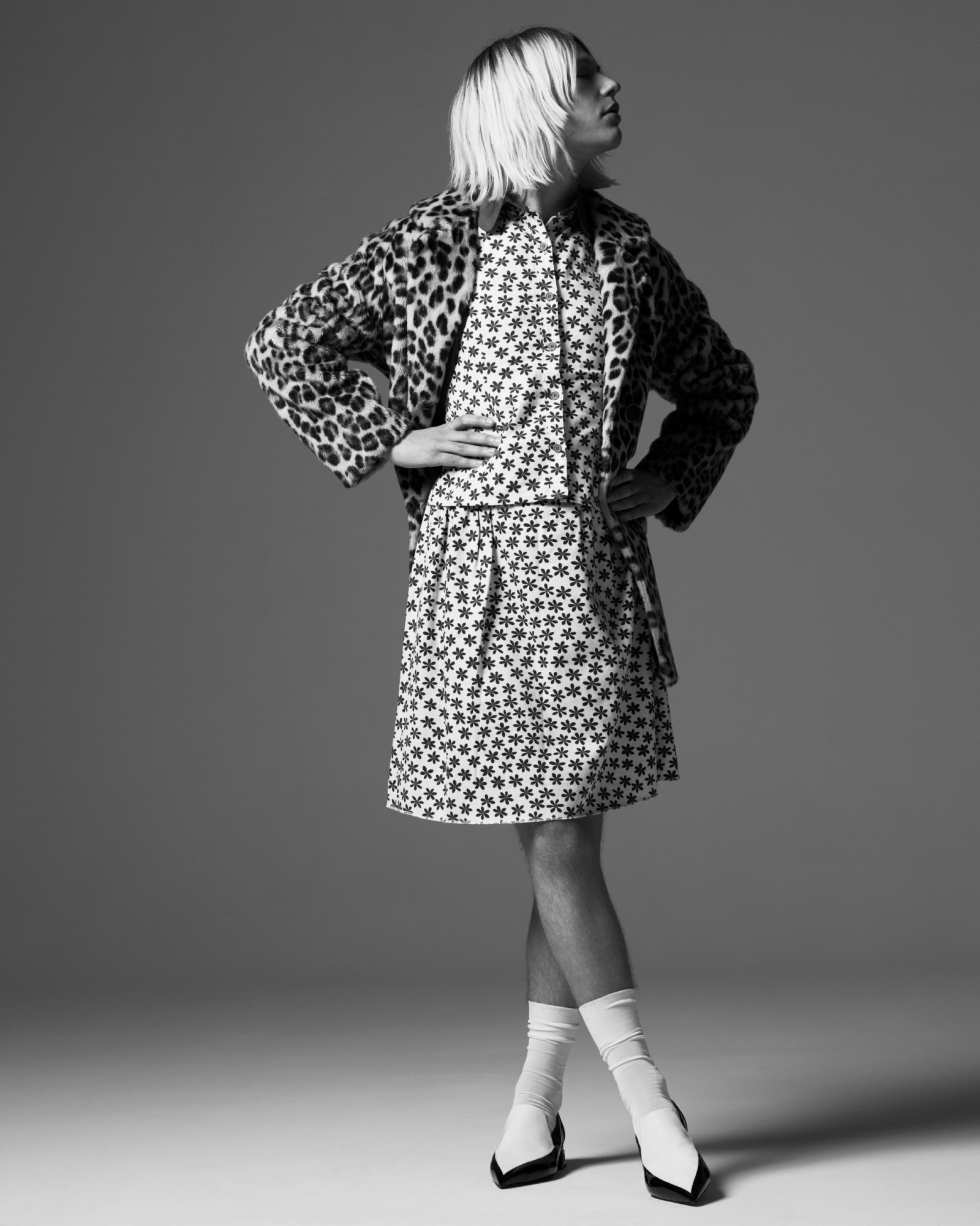 Jack of Walt Disco wearing a two piece floral shirt and skirt combination, leopard print coat, white socks and loafer-style two-tone louboutin heels