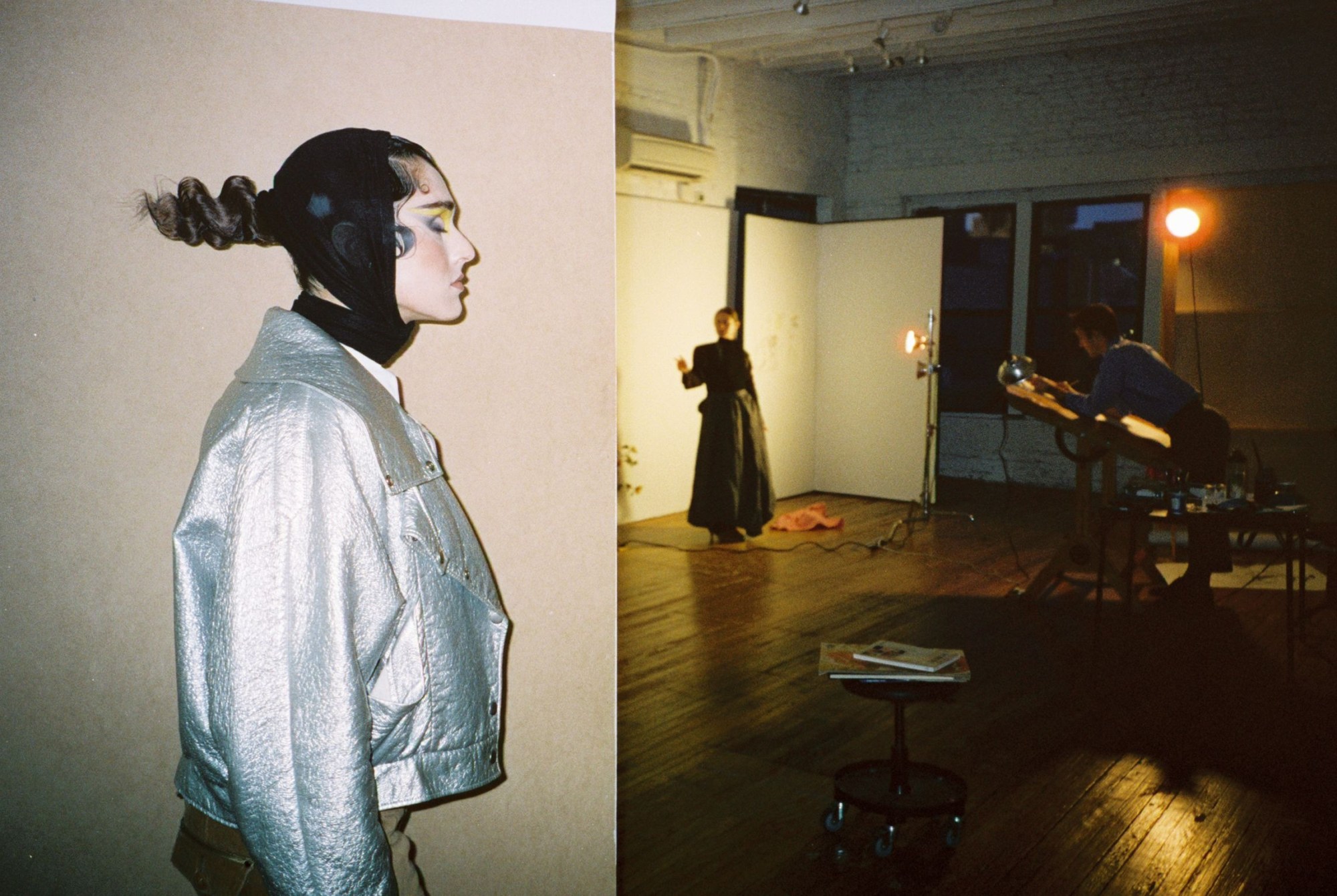 a woman in a silver jacket poses in profile while in the background artist drake carr sketches another model