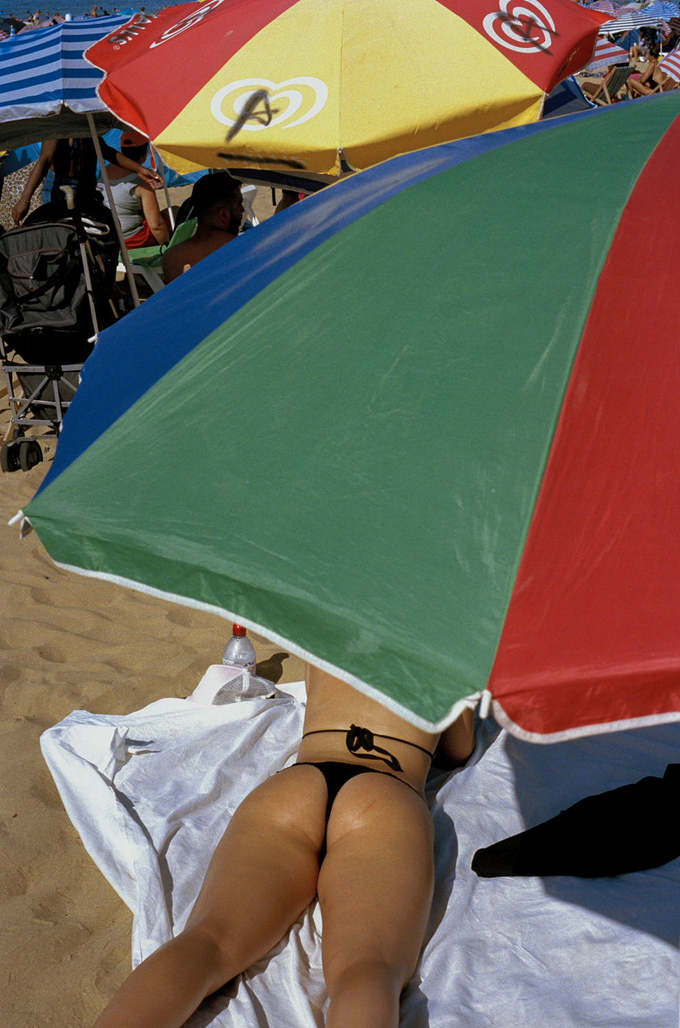 a woman tanning on her stomach on the beach